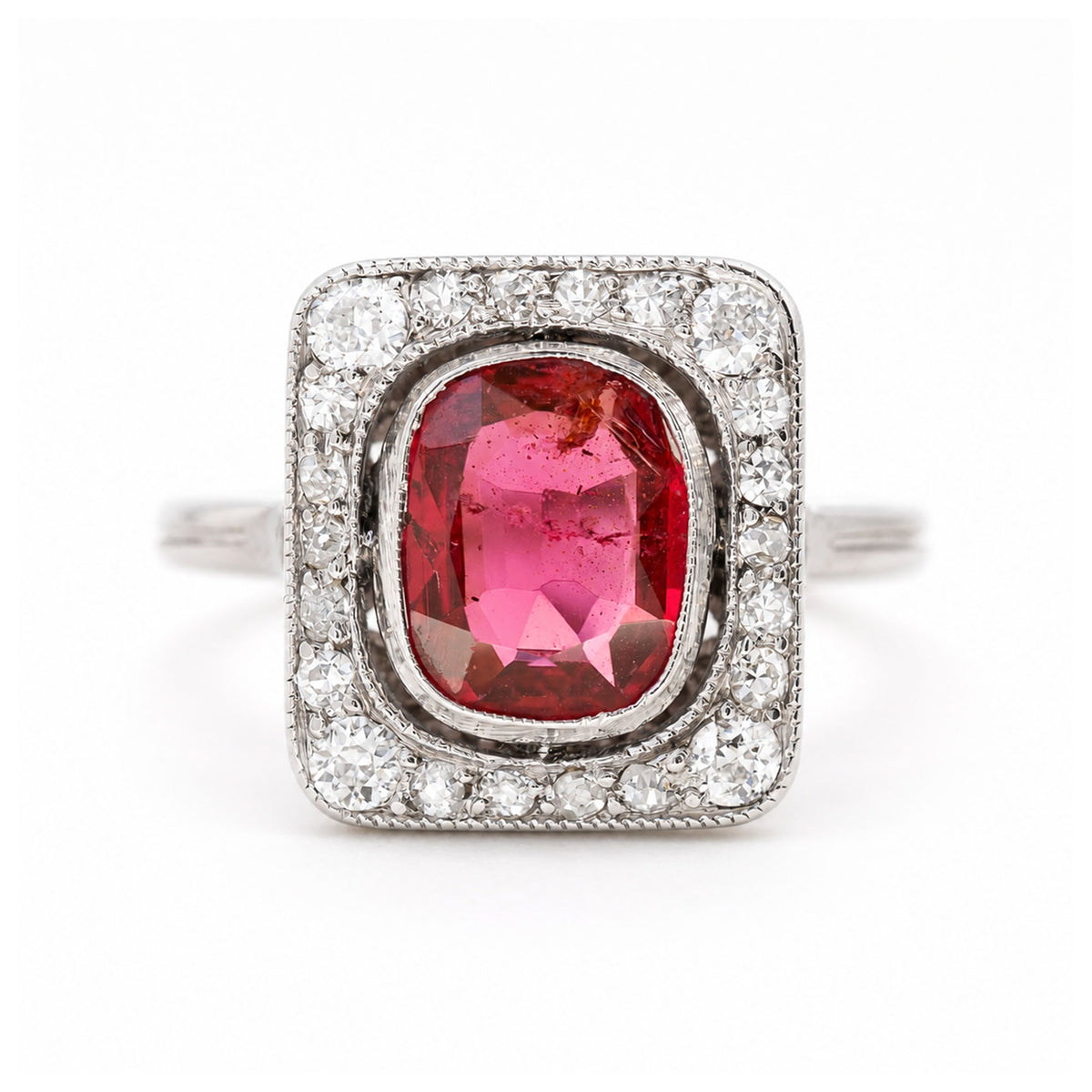 A close up of an antique, Art Deco saturated red spinel and diamond cluster ring in platinum.