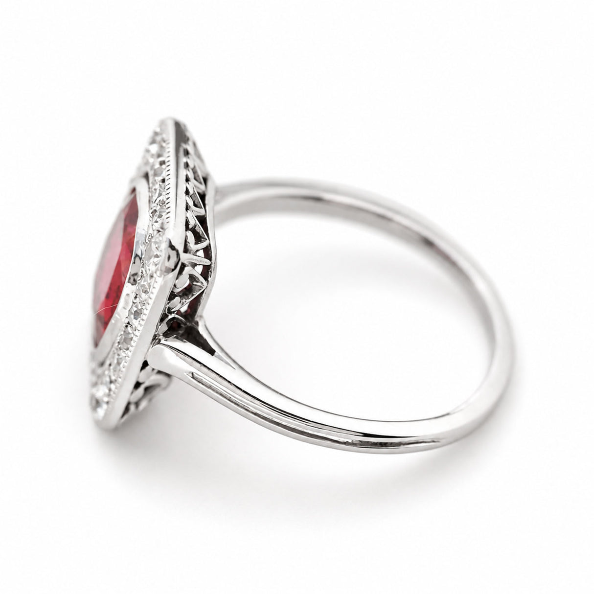 A side profile of an antique, Art Deco red spinel and diamond cluster ring set in platinum.