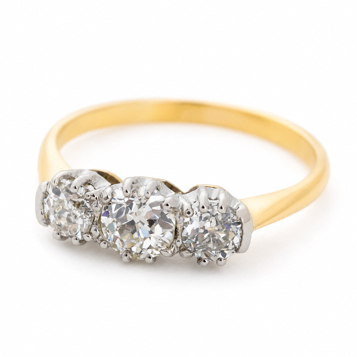 An antique three-stone old-cut diamond engagement ring set with platinum and yellow gold.