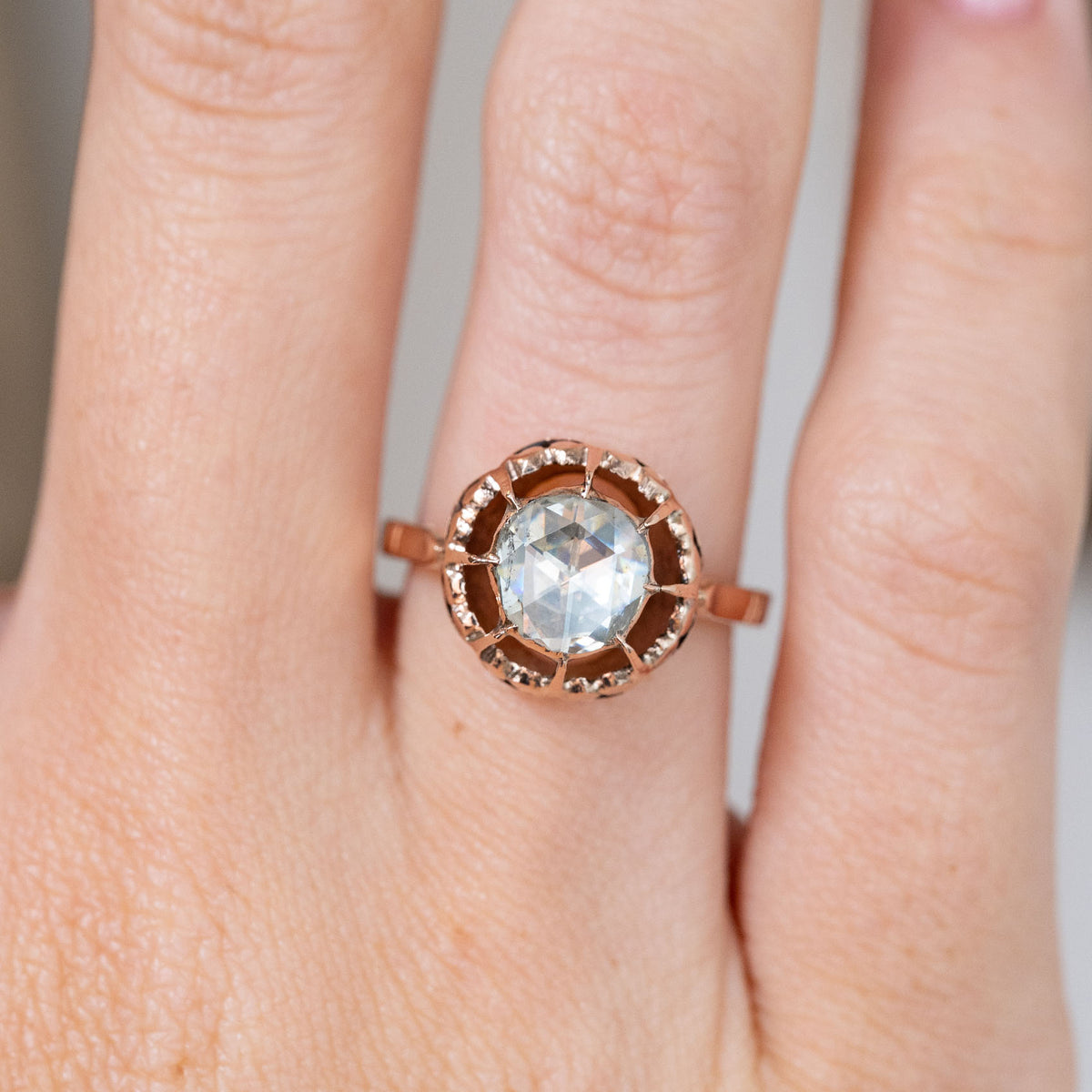 A closer finger detail highlights the softly faceted antique diamond, warm-toned gold and characterful Victorian craftsmanship.