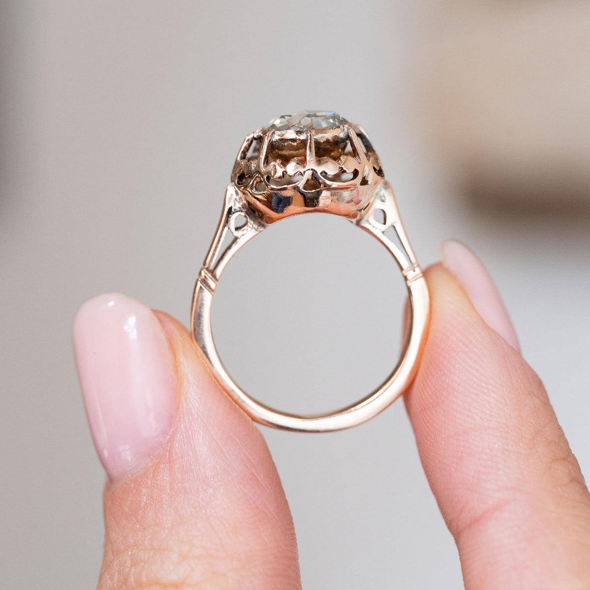 Rear profile of the Victorian solitaire showing the intricate open-backed mount and fine 12ct yellow gold band.