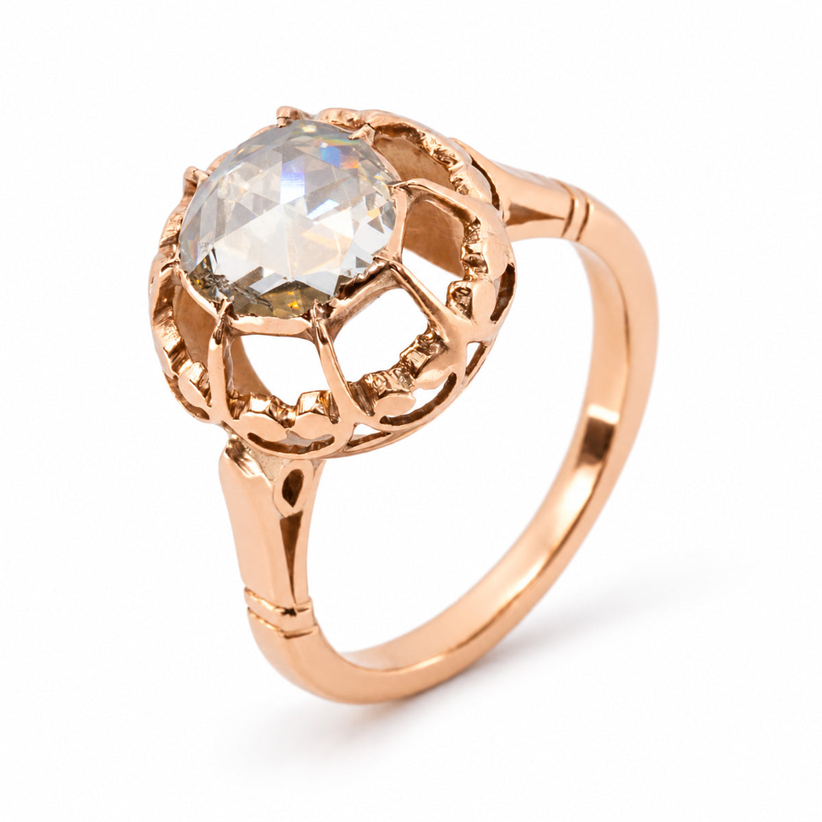 Three-quarter studio study of the Victorian diamond ring, revealing its high rose-cut stone, decorative circular mount and slender gold shank.