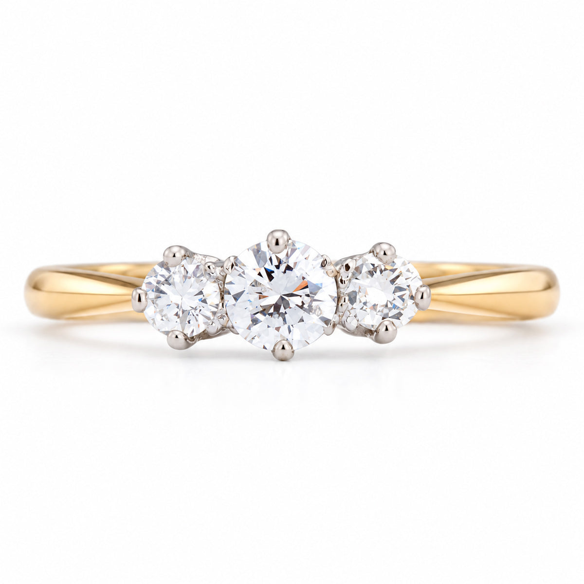 Antique Edwardian diamond three-stone engagement ring, with three claw-set diamonds in platinum on a yellow gold band.