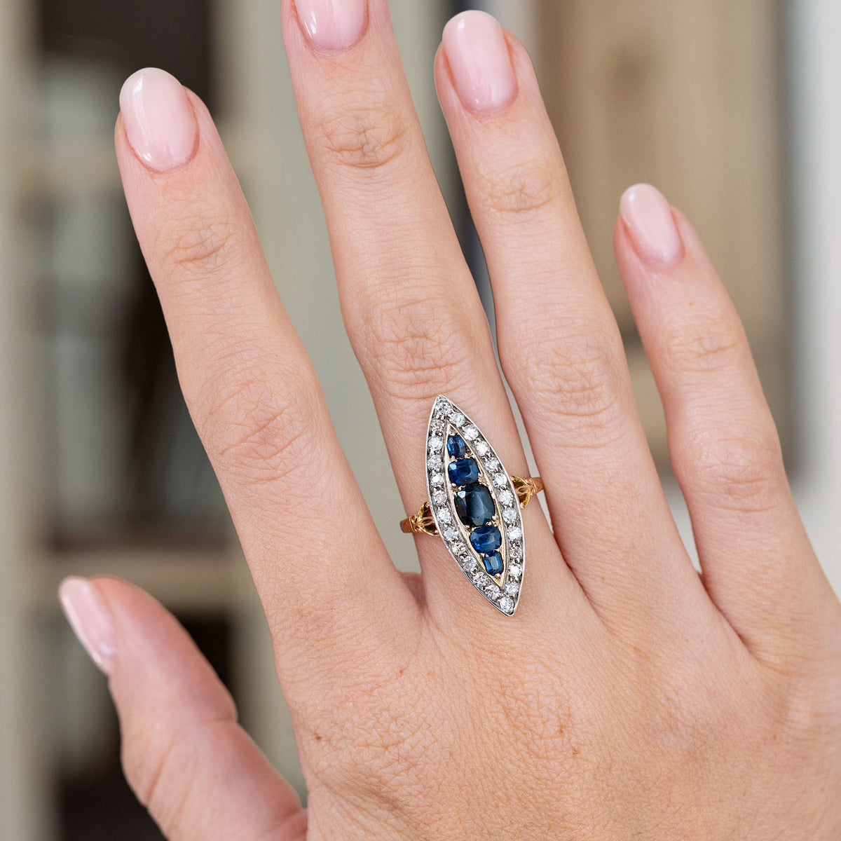 Modelled on the hand, this Victorian navette ring creates a dramatic elongated silhouette with graduated blue sapphires and diamonds.