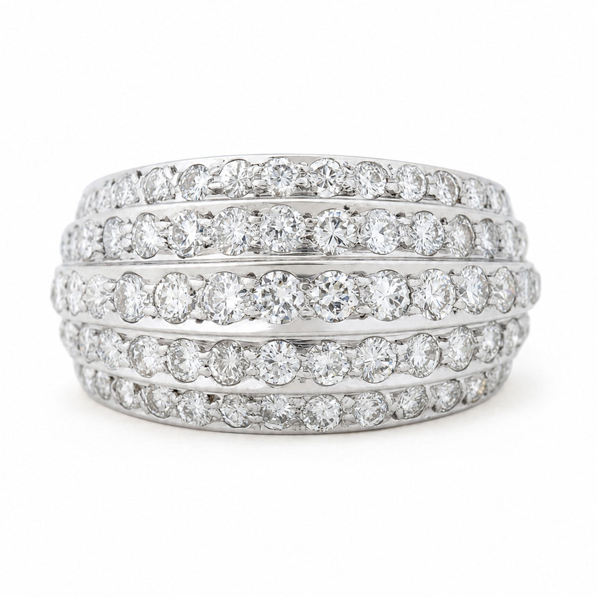 A Vintage, 1950s diamond bombe cocktail ring in white gold against a white background