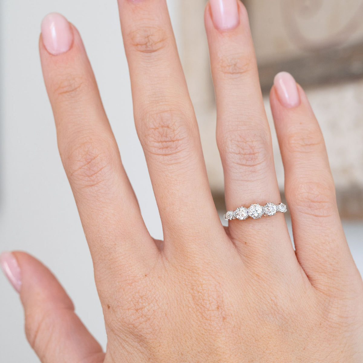Modelled on the hand, the graduated diamond arrangement curves gracefully across the finger in a classic Edwardian design.