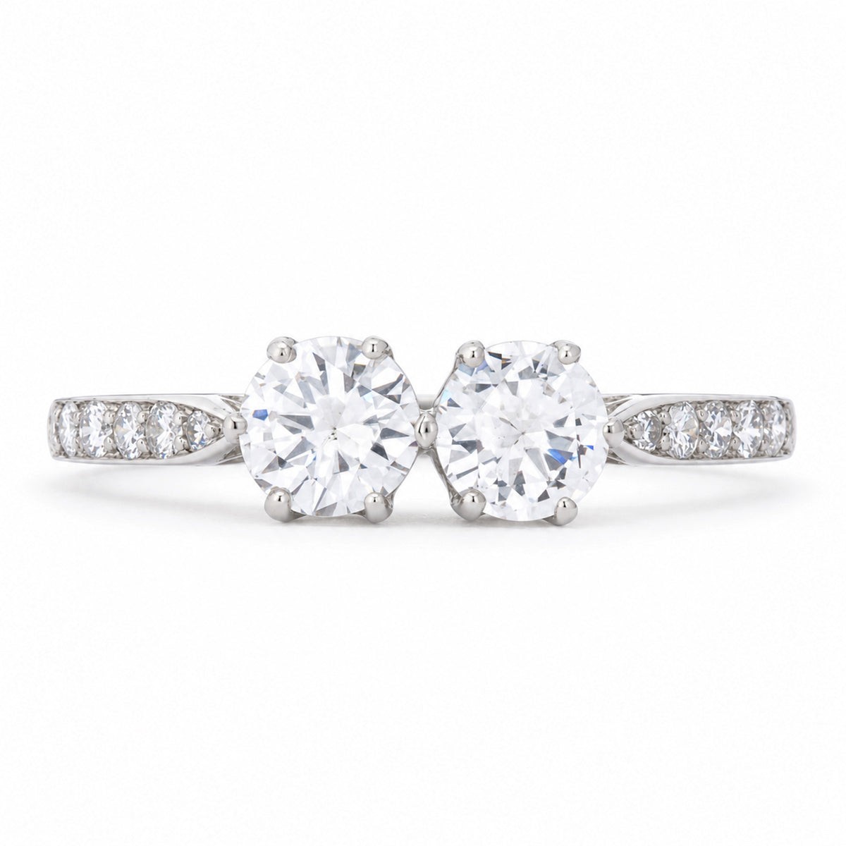 Antique Art Deco diamond toi et moi engagement ring in platinum, set with two round transition-cut diamonds and diamond-set shoulders.
