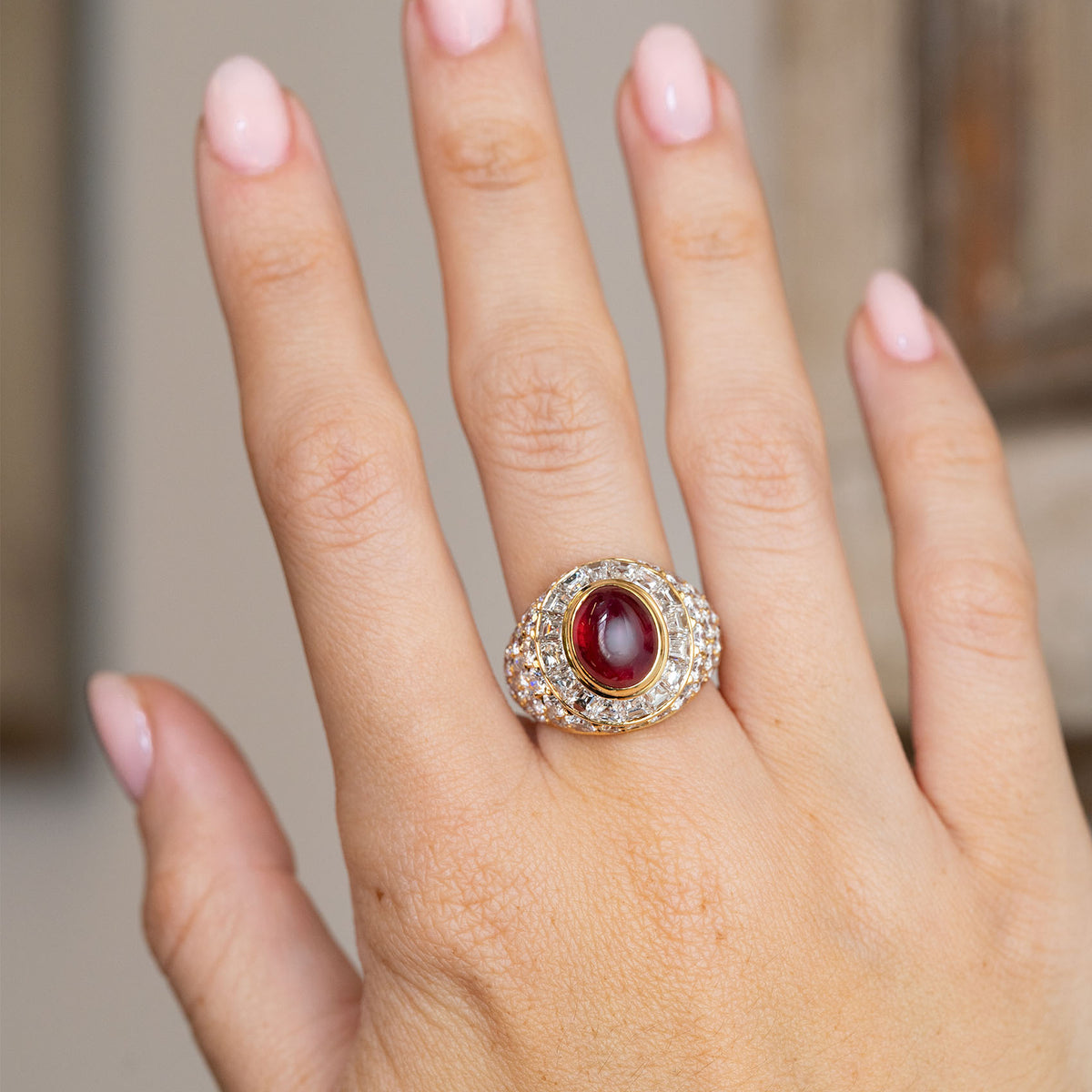 Asprey ruby and diamond cocktail ring worn on the hand, showcasing its bold statement scale and sculptural form.