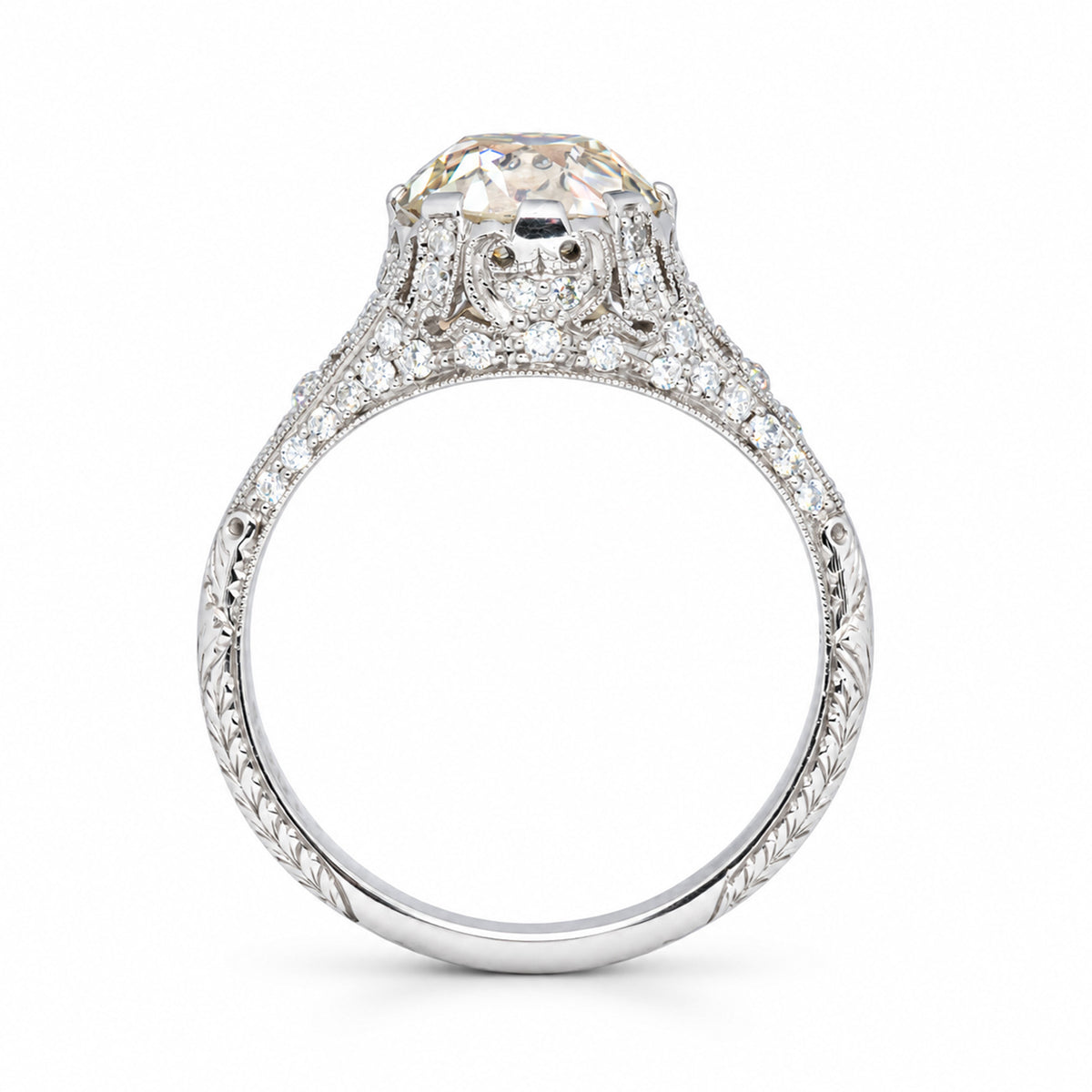 Reverse profile of the antique engagement ring, revealing the ornate gallery and finely engraved diamond-set band.