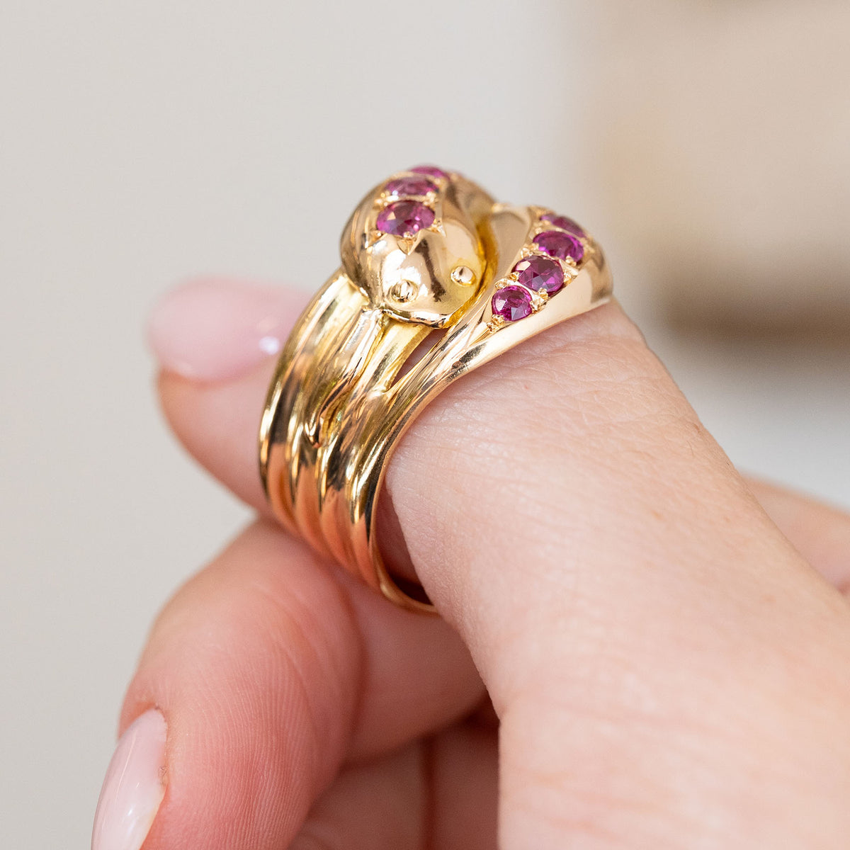 Side profile of the Victorian ruby ring on the finger, revealing its substantial layered yellow gold band.