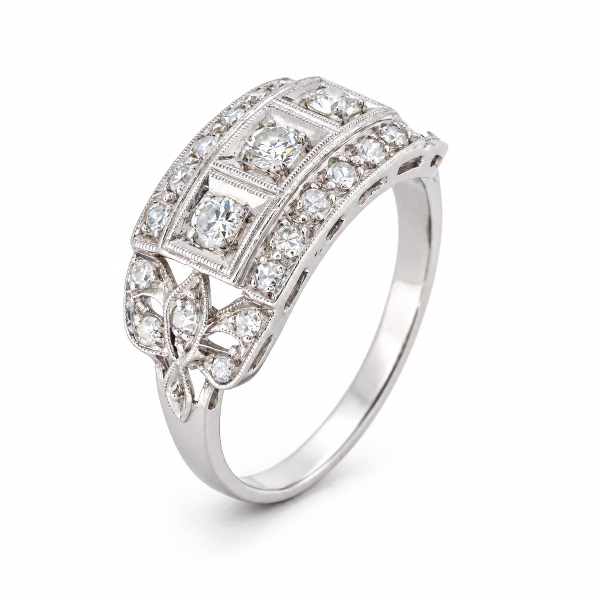 Three-quarter studio portrait of the antique platinum ring, showcasing its architectural Art Deco setting and ornate pierced shoulders.