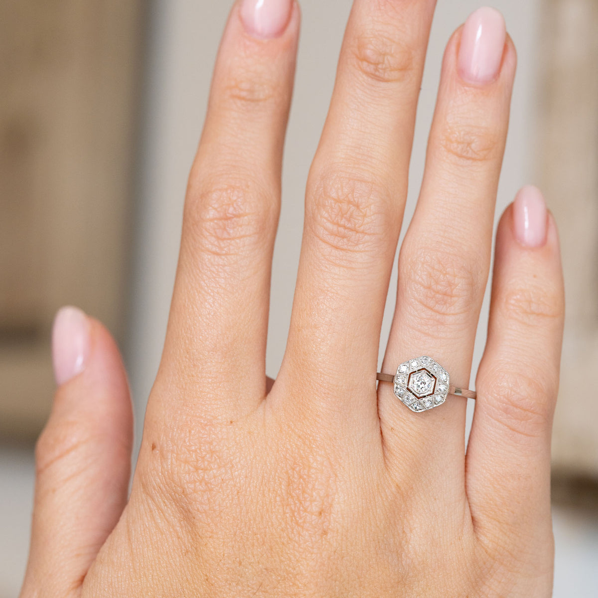 Antique geometric diamond cluster displayed on the hand, showing the ring’s elegant scale and crisp hexagonal outline.