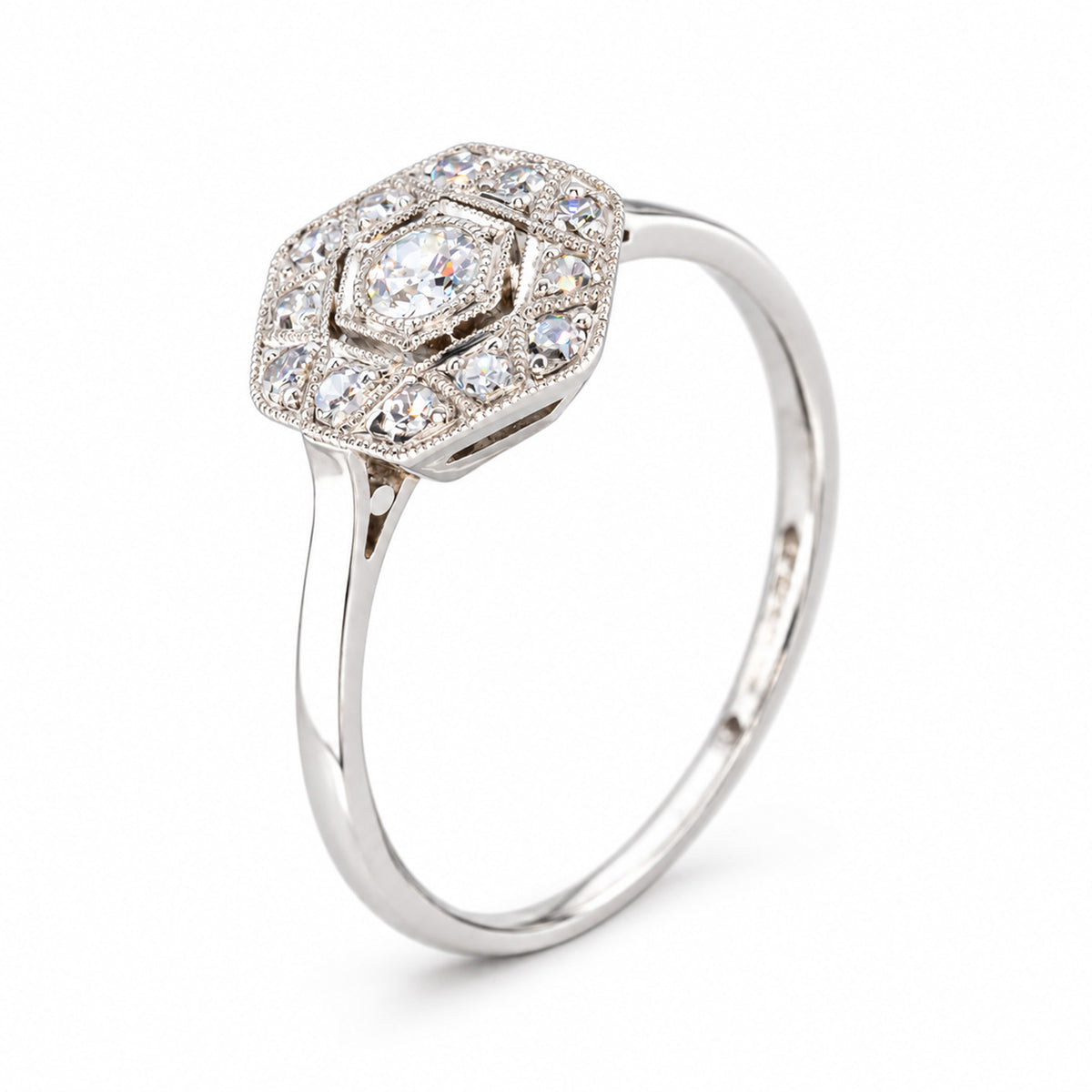 Three-quarter studio view of the antique diamond ring, showcasing its layered Art Deco cluster and slender white gold band.