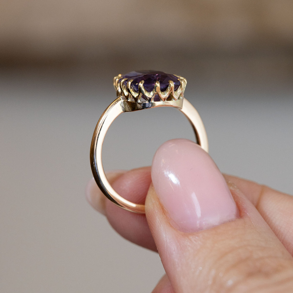 Side profile of the antique Edwardian sapphire ring, revealing the decorative openwork gallery and polished yellow gold band.