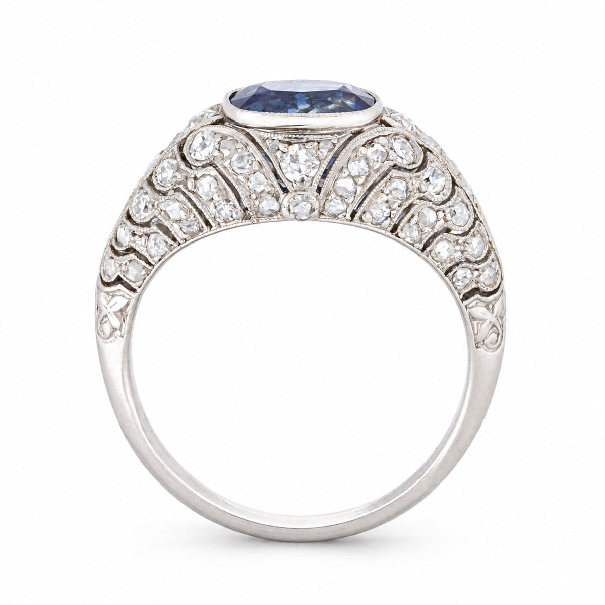 Side profile of a Belle Époque sapphire and rose-cut diamond ring, showcasing its domed silhouette and ornate platinum openwork.