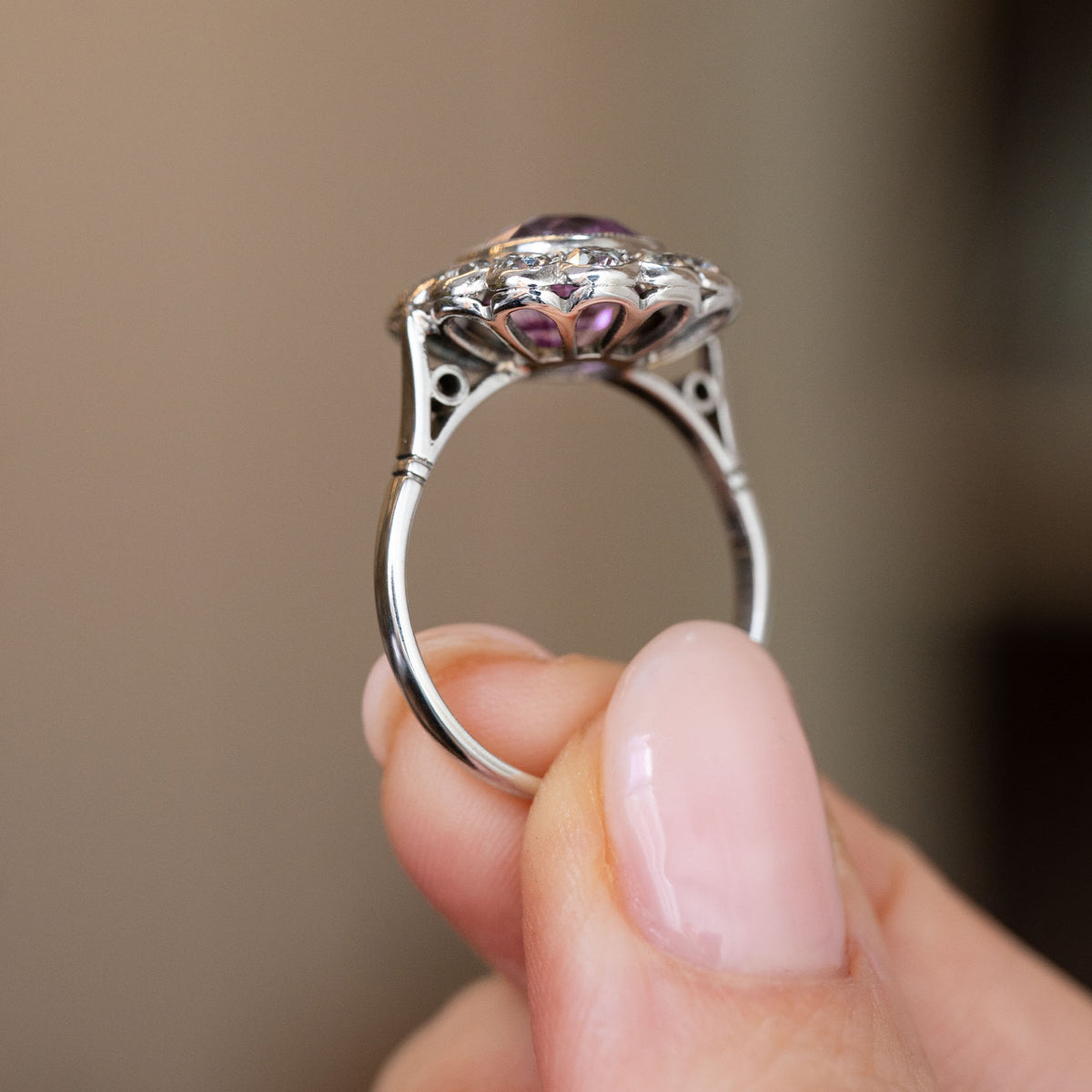 Profile of the white gold and platinum engagement ring, showing its elevated gallery and finely tapered band.