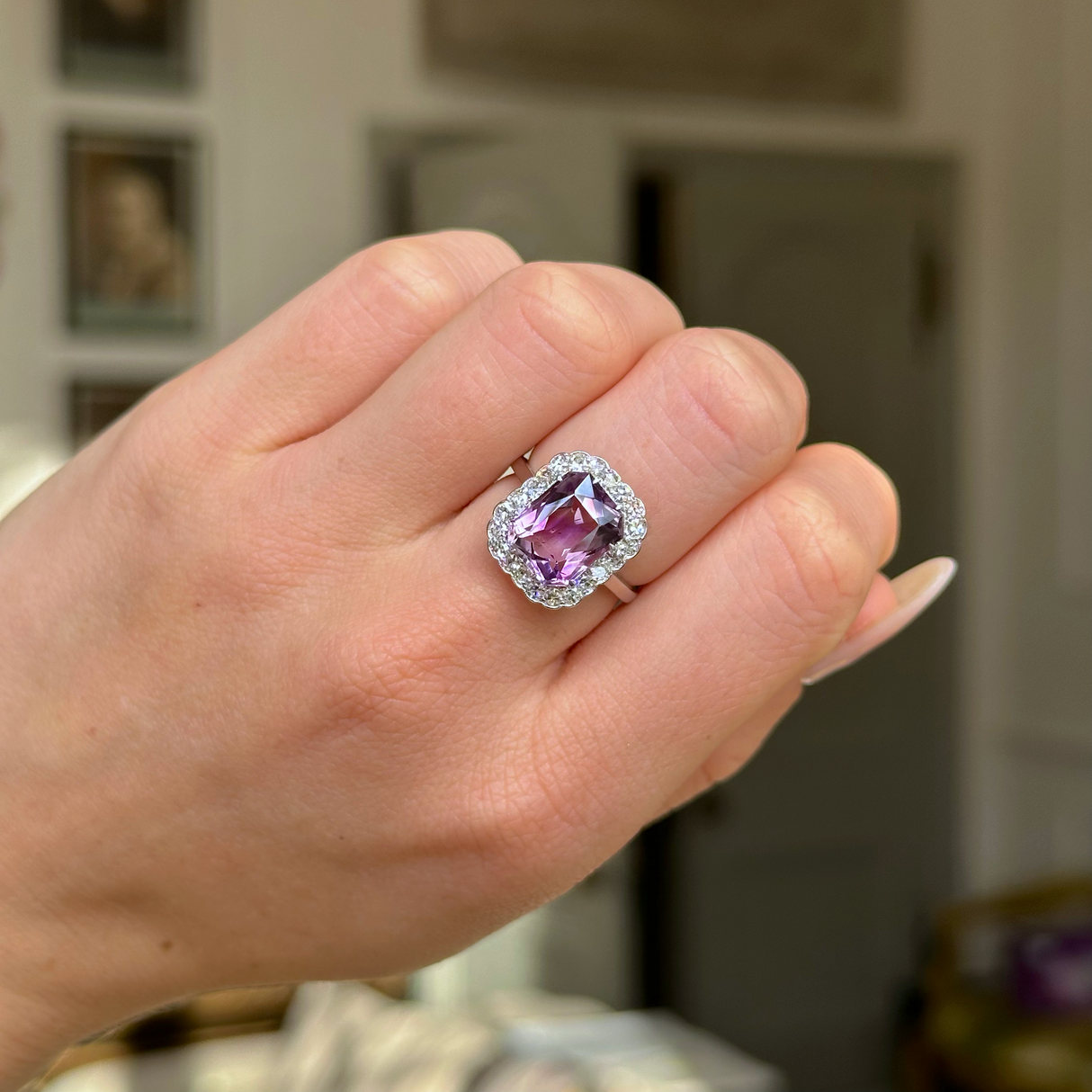 antique belle epoque amethyst and diamond cluster ring worn on closed hand.