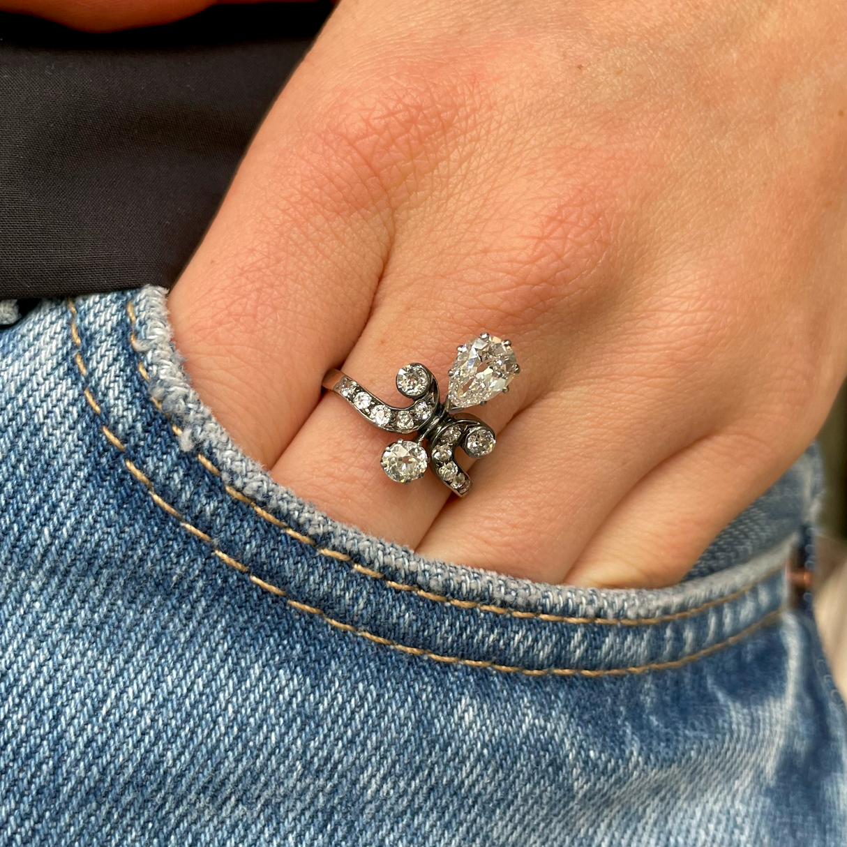 antique pear cut diamond ring, worn on hand.