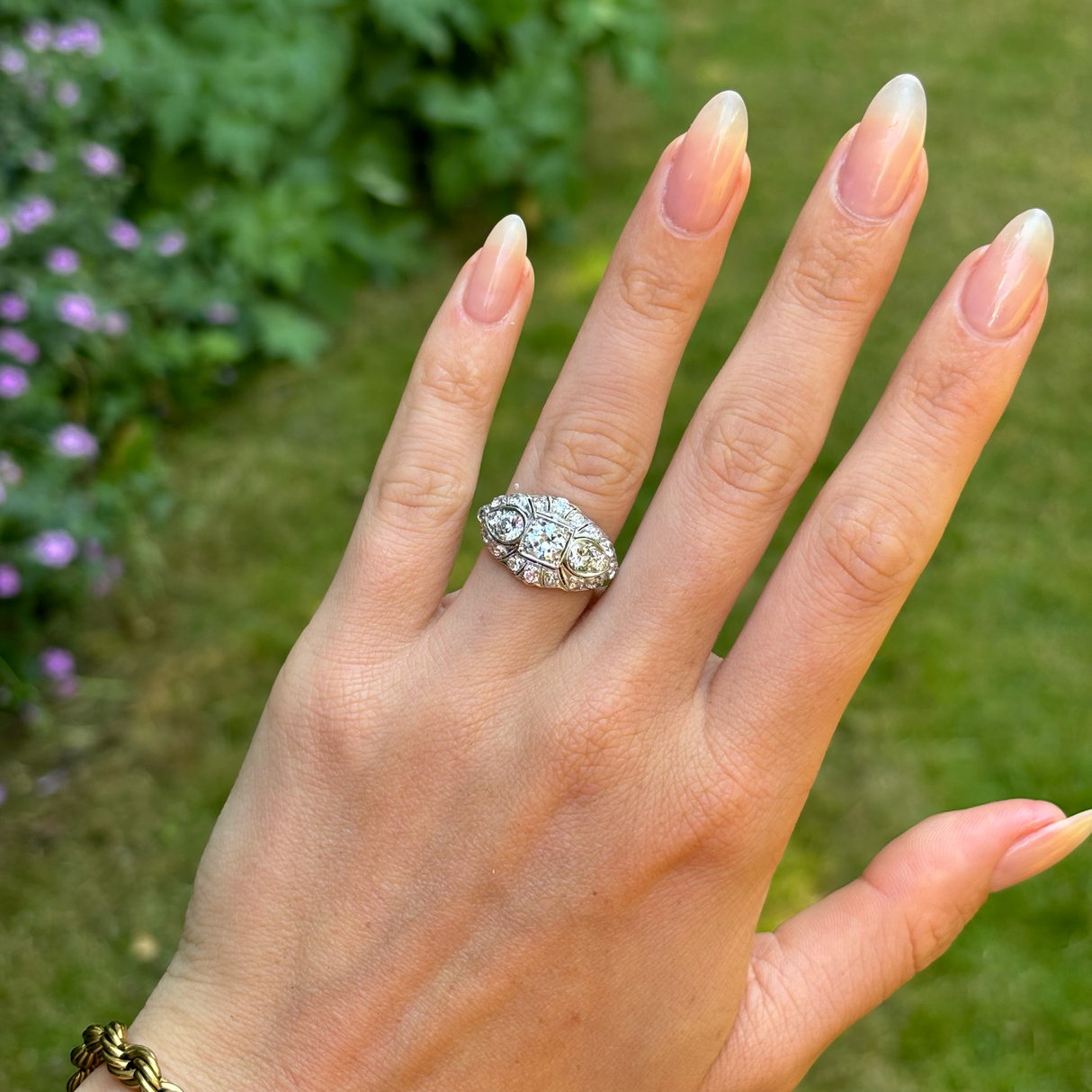 Antique, Belle Époque diamond bombé ring, platinum worn on hand.