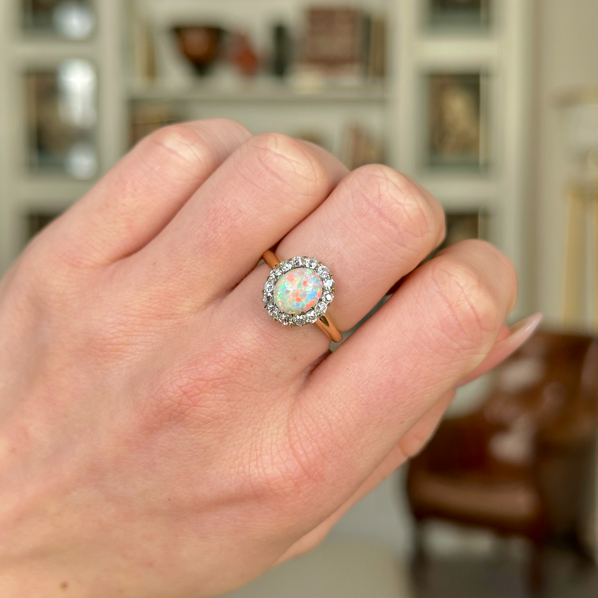 Antique, Edwardian White Opal and Diamond Cluster Ring worn on closed hand.