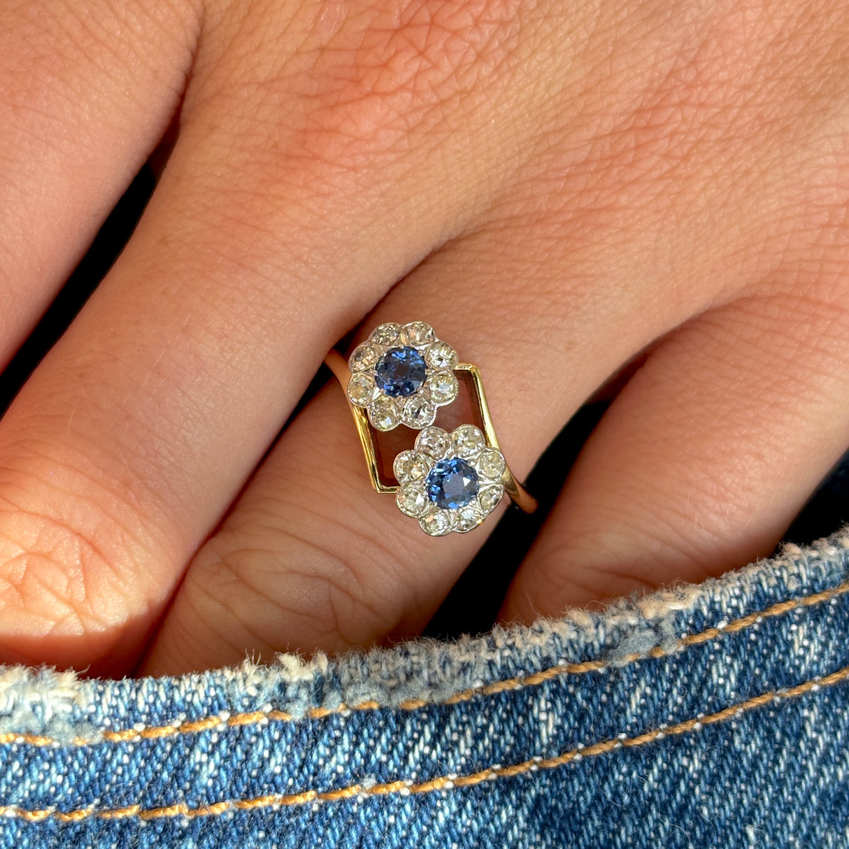 Antique, Edwardian sapphire & diamond double cluster ring worn on hand.