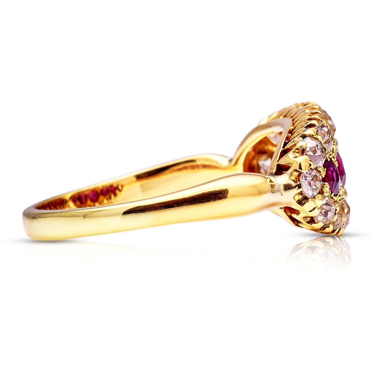 Ruby and diamond cluster engagement ring side view.