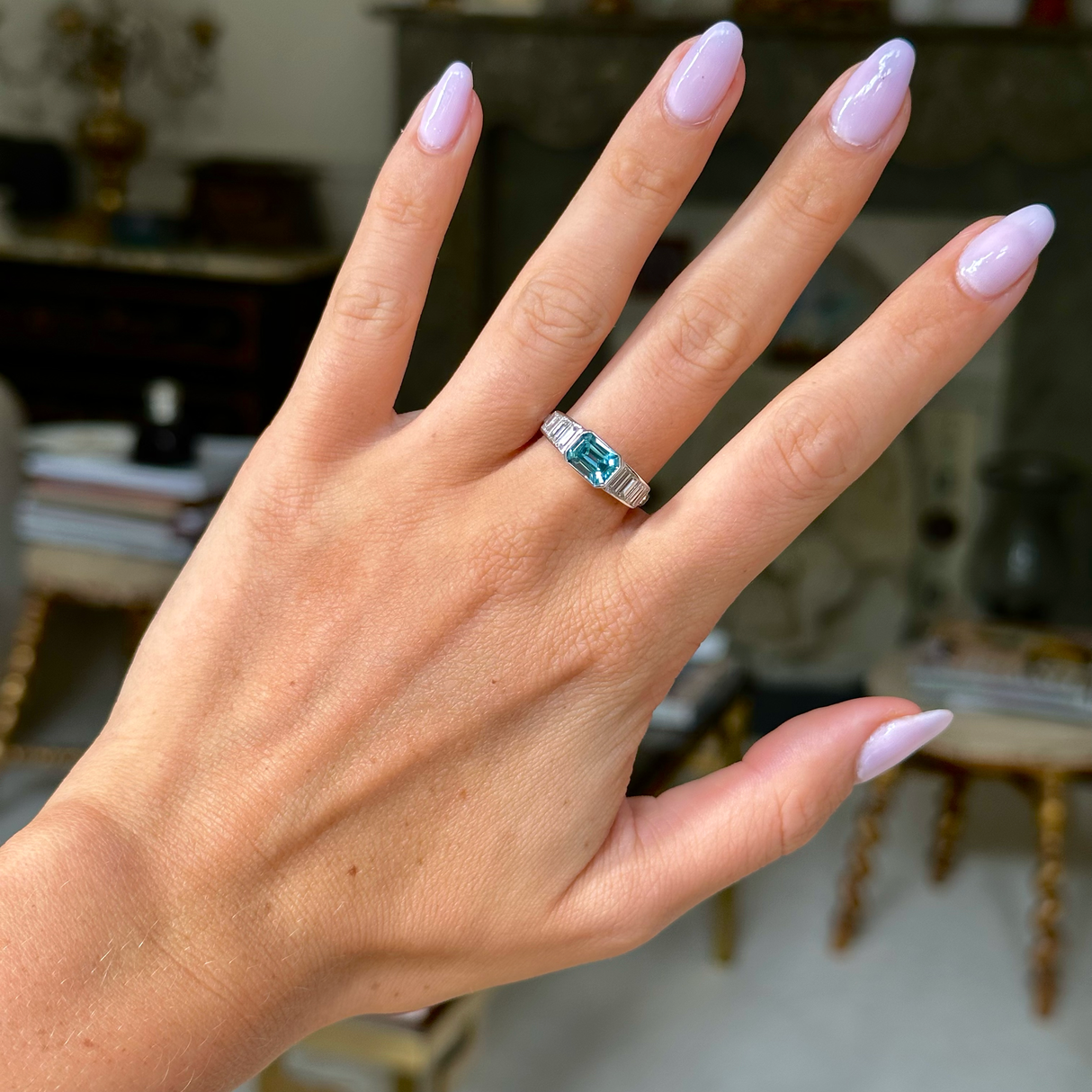 Vintage zircon and diamond ring, worn on hand, front view.