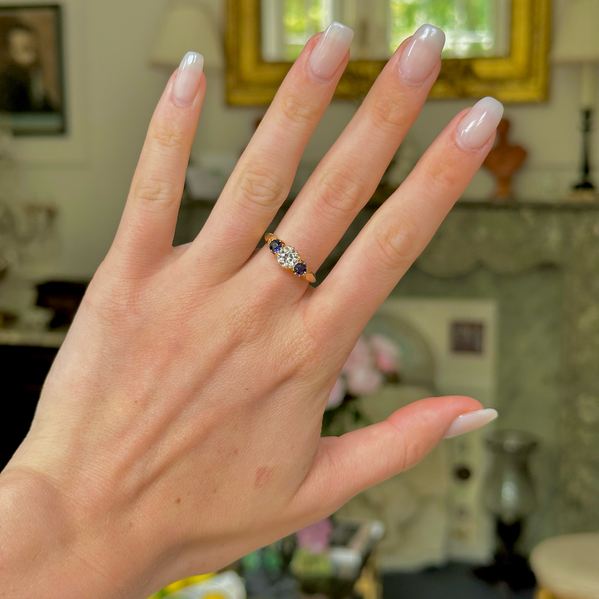 Antique, central white sapphire and blue sapphire three stone ring, 18ct yellow gold