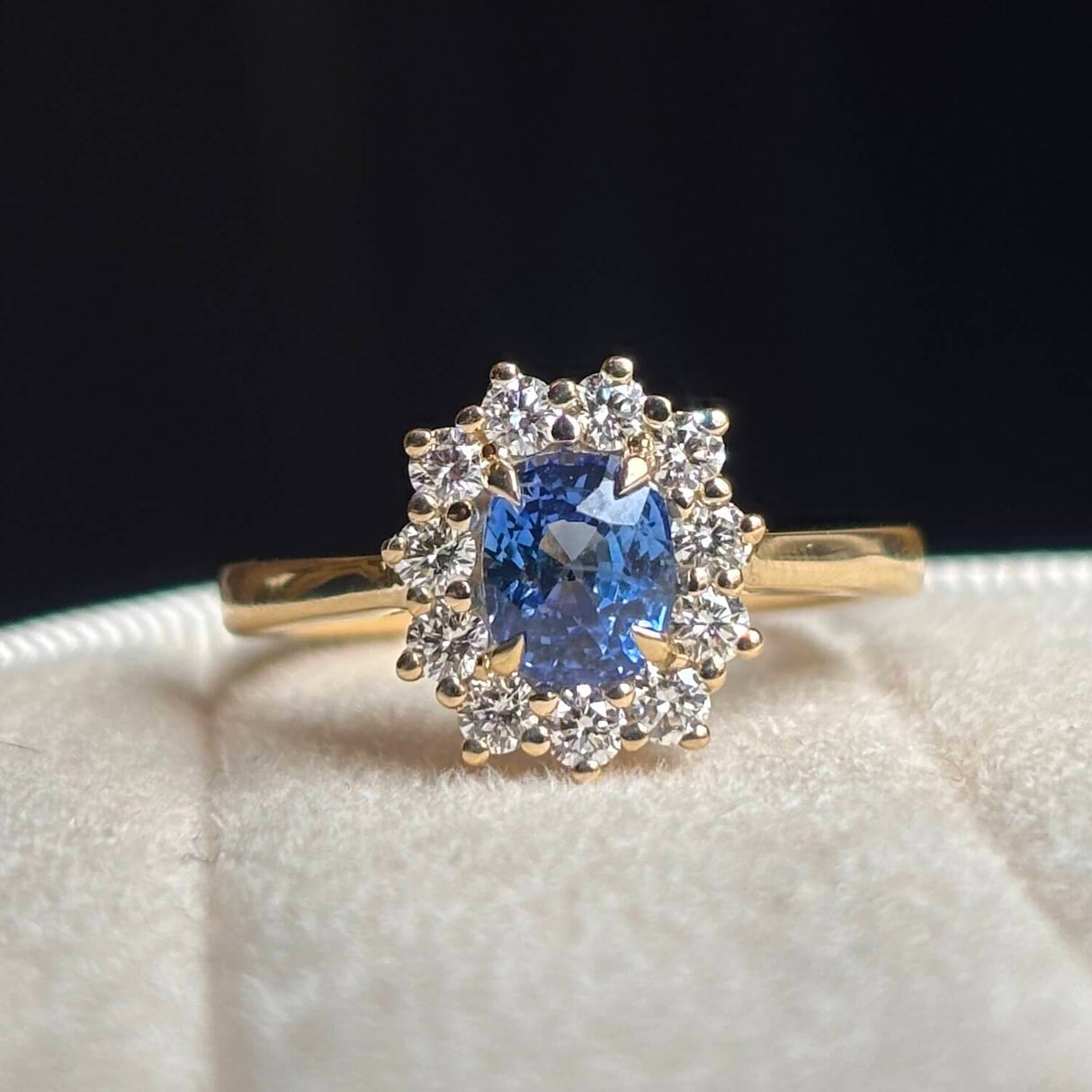 Blue sapphire and diamond cluster engagement ring close up
