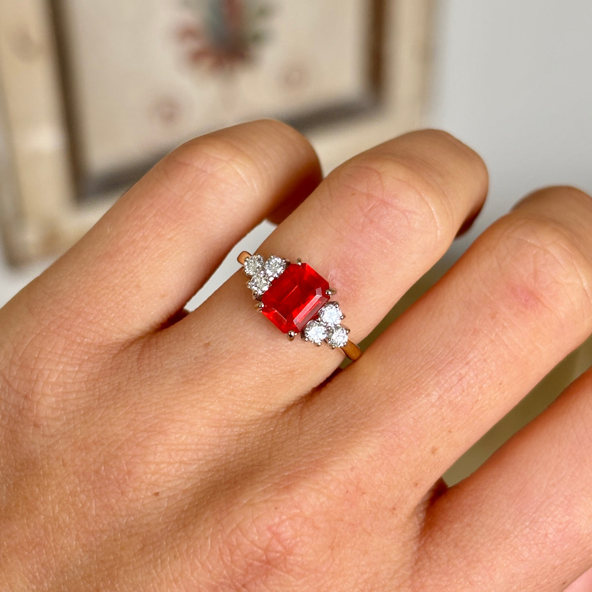 Vintage red fire opal and diamond clustering worn on hand