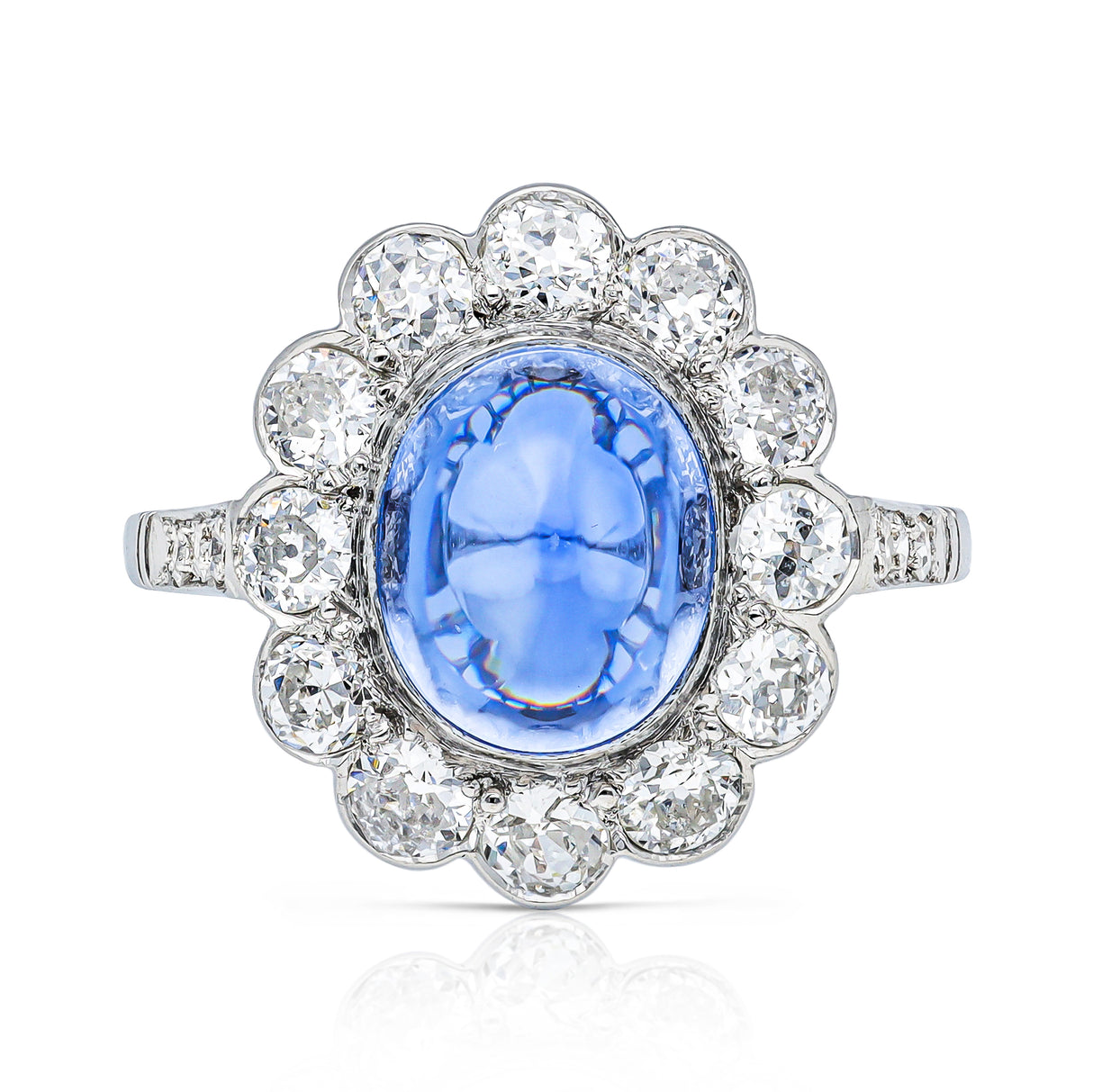cabochon sapphire and diamond cluster ring set in platinum, front view.