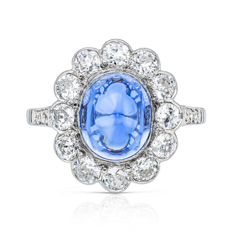 cabochon sapphire and diamond cluster ring set in platinum, front view.