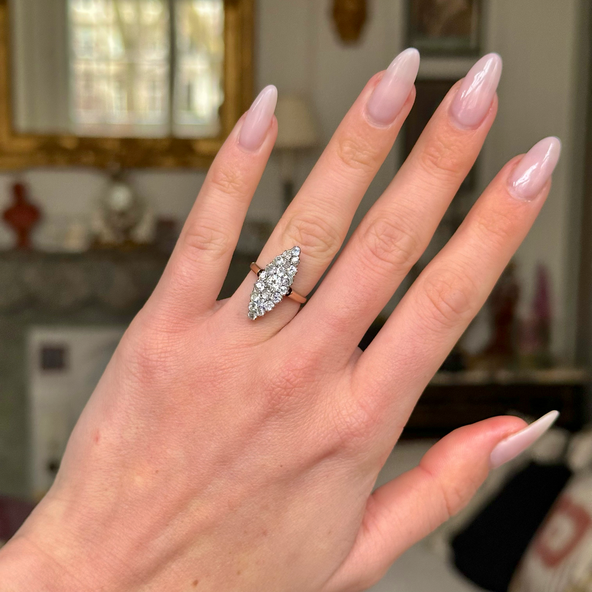 Antique diamond navette ring worn on hand.