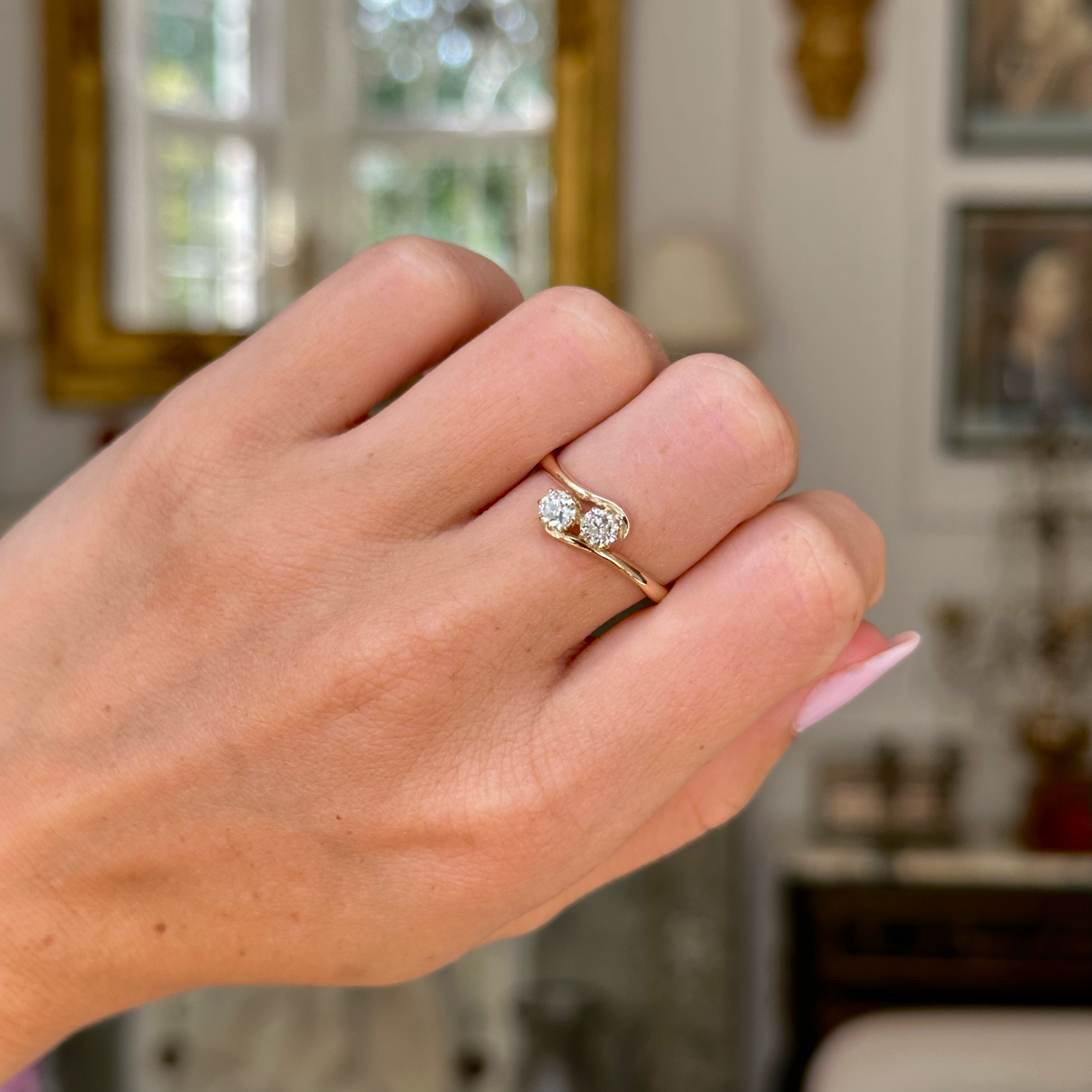 Antique diamond toi et moi ring worn on closed hand.