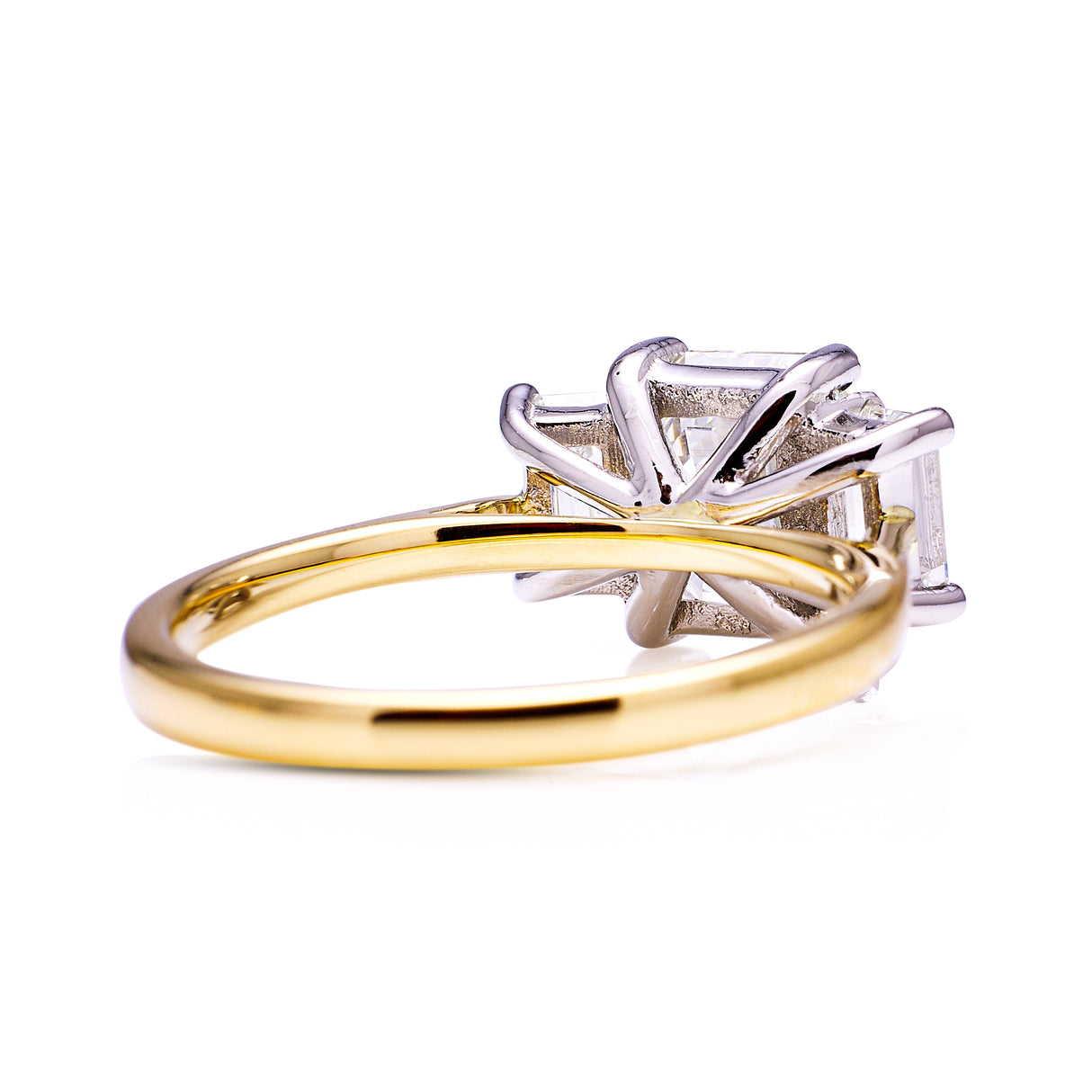 Three stone emerald-cut diamond ring, rear view
