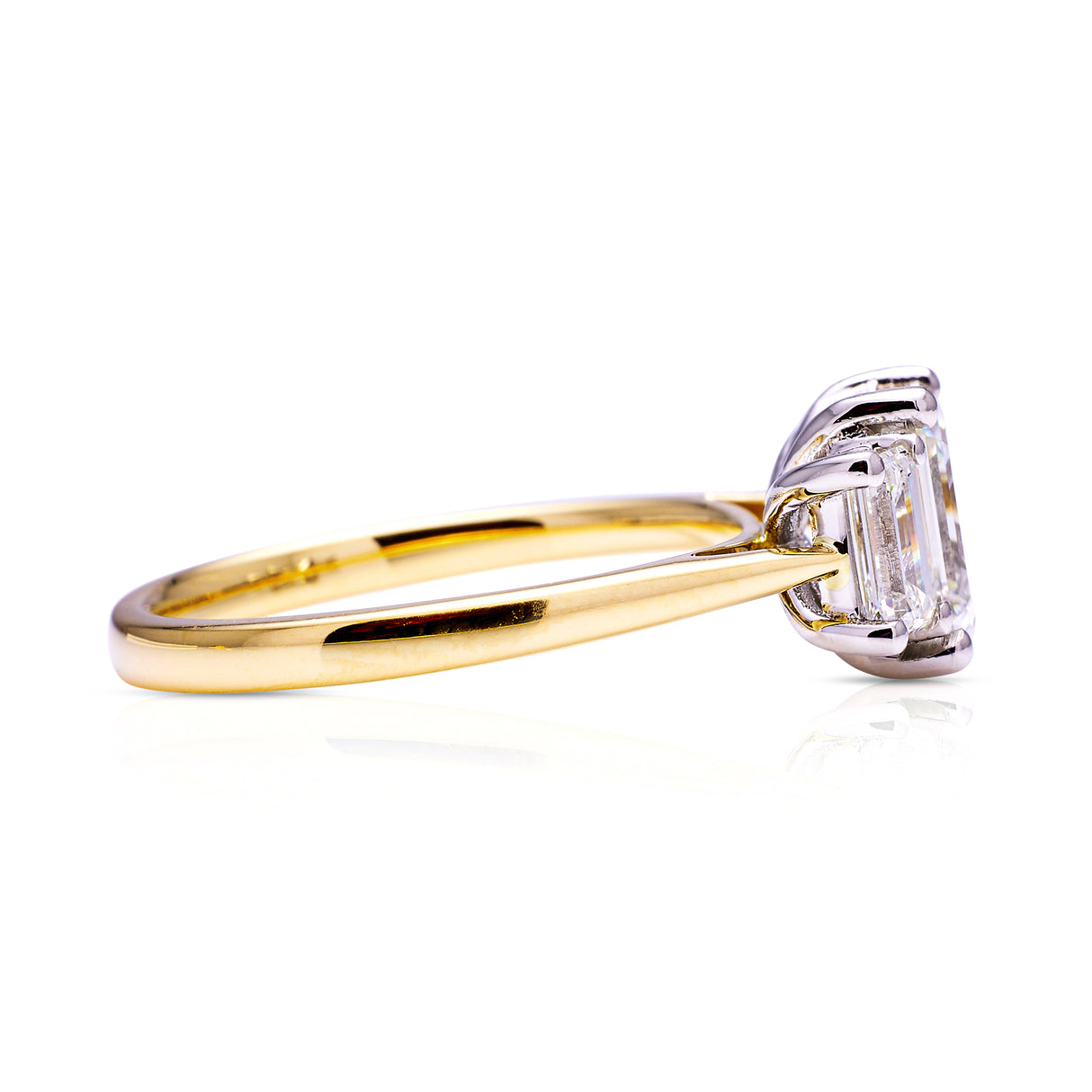 Three stone emerald-cut diamond ring, side view