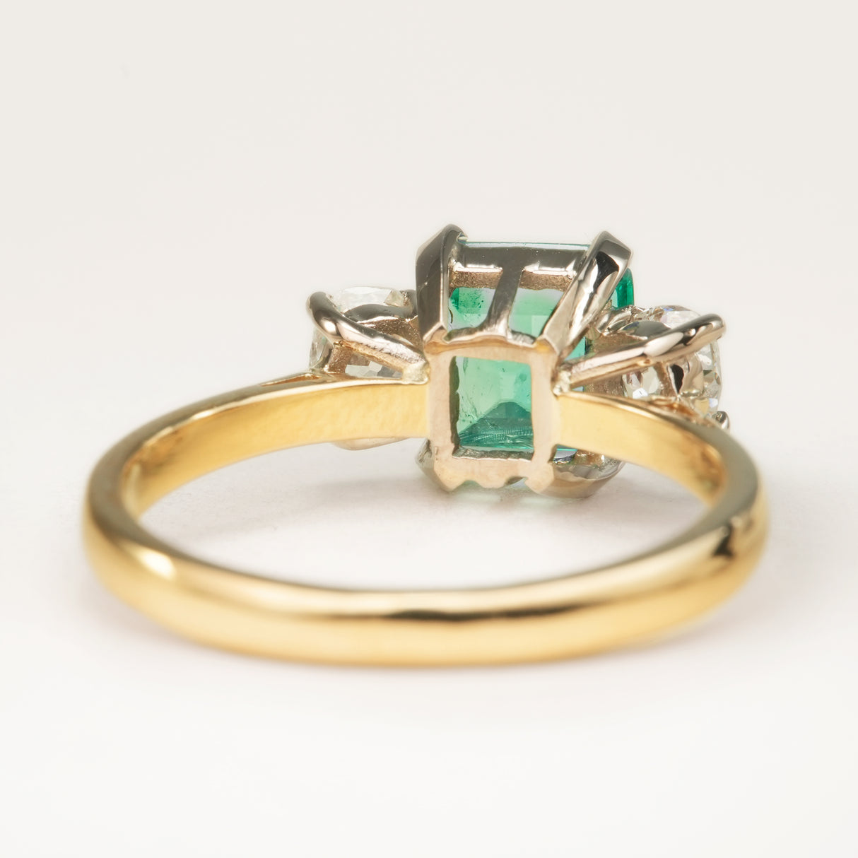 Vintage, emerald and diamond three-stone engagement ring