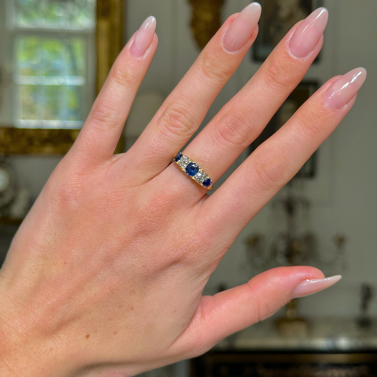 edwardian sapphire and diamond five stone ring, worn on hand.