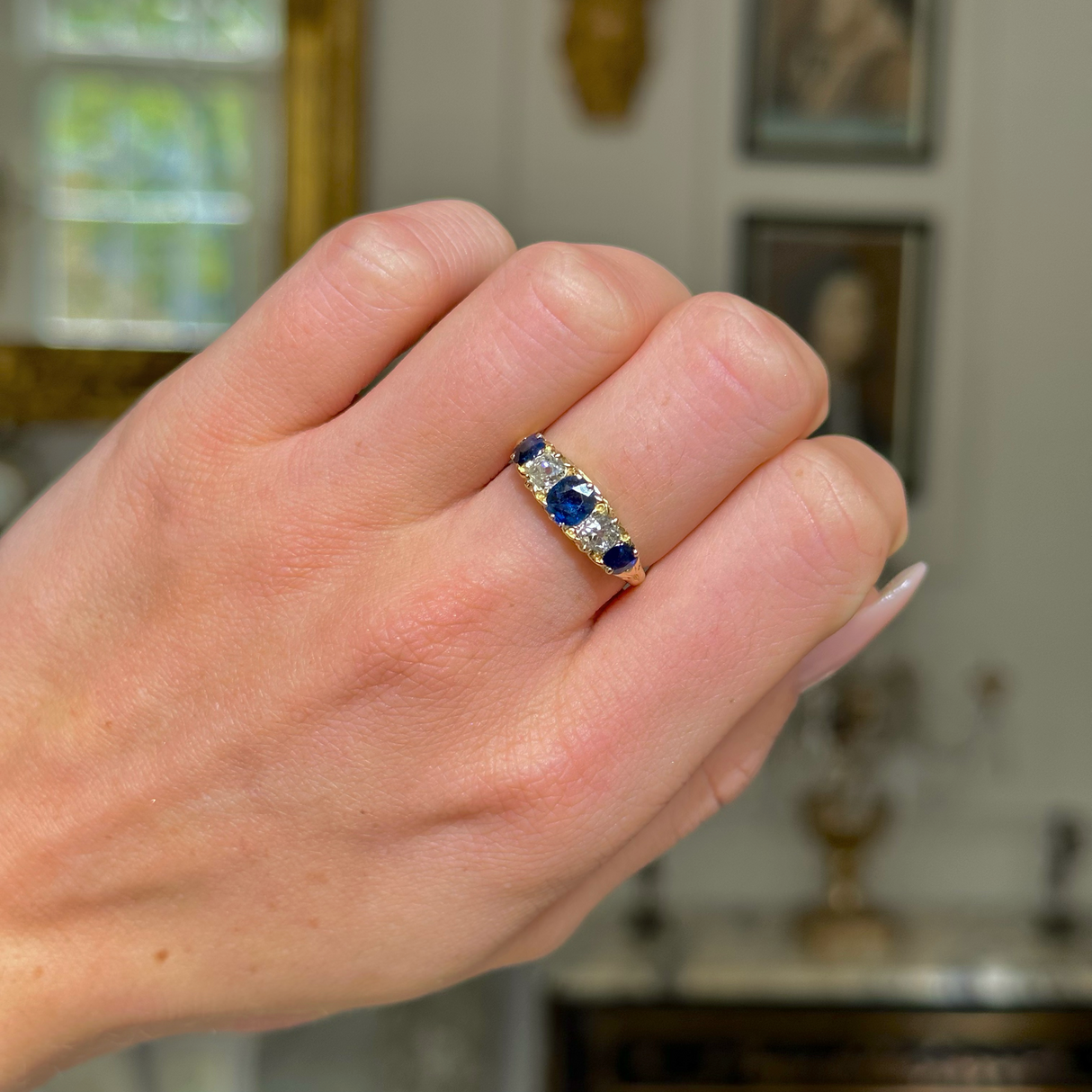 edwardian sapphire and diamond five stone ring worn on closed hand.