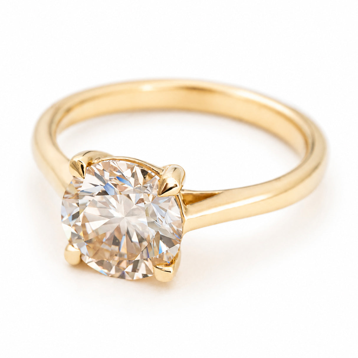 Antique-inspired, Light brown diamond solitaire engagement ring against a white background seen from an angle to show the band