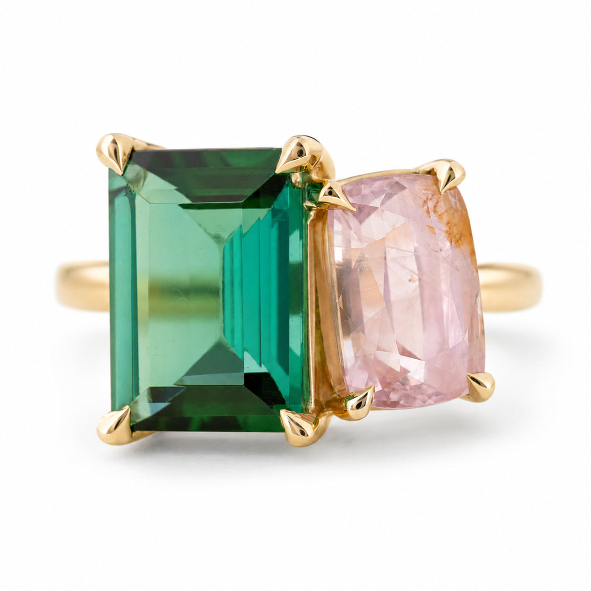 A yellow gold Vintage-inspired, Green tourmaline and pink sapphire Toi et Moi engagement ring, set against a clean white background.