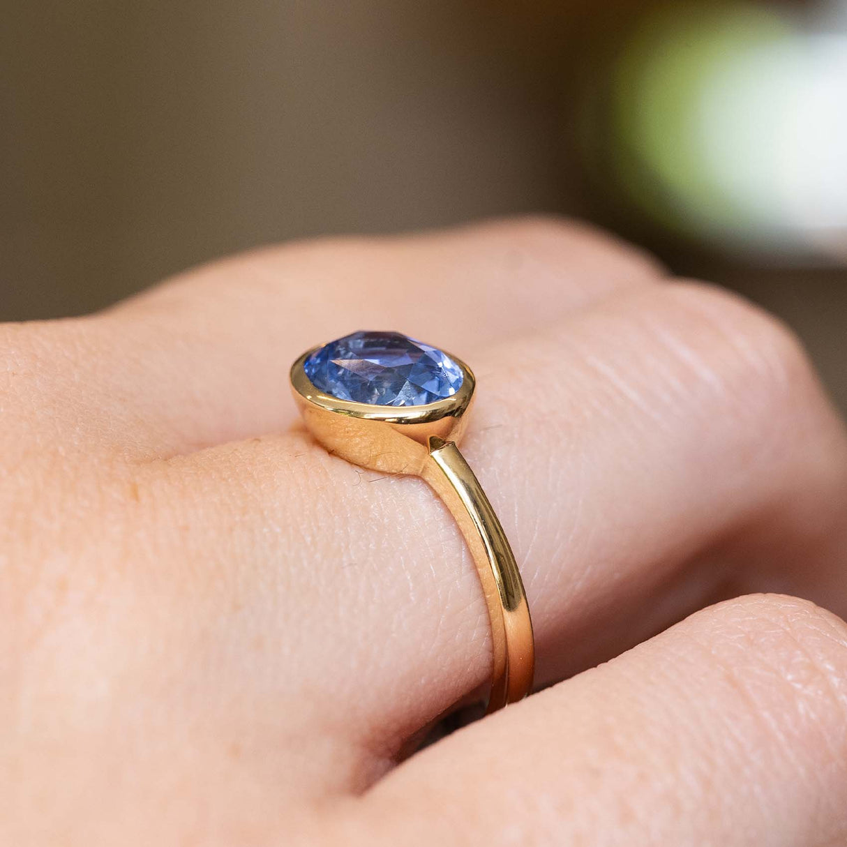 Side view of an antique-inspired blue sapphire solitaire ring in yellow gold.