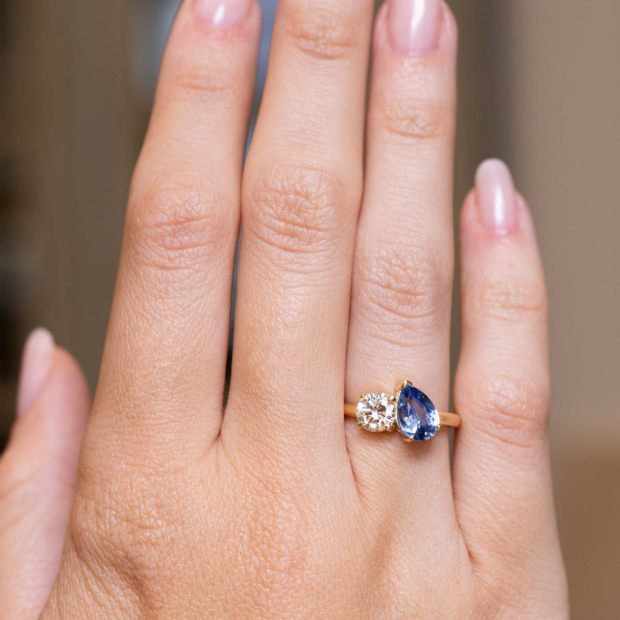 Photograph of antique-inspired blue sapphire and diamond engagement ring shown at full scale