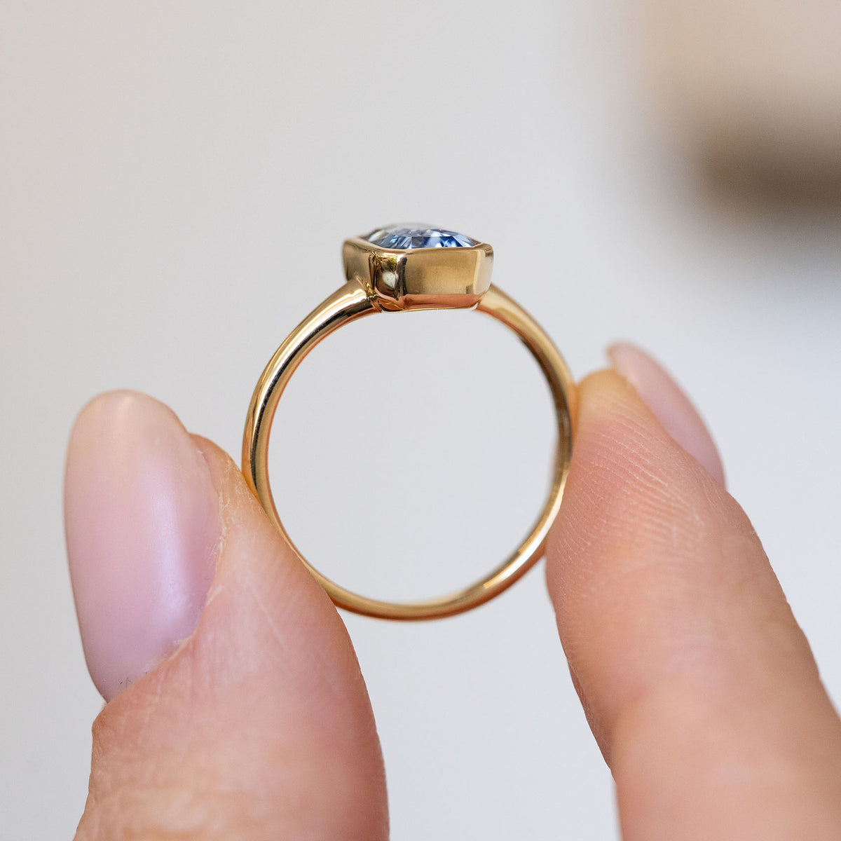 Profile view of the antique-inspired ring, displaying the elevated gemstone setting and slender yellow gold shank.