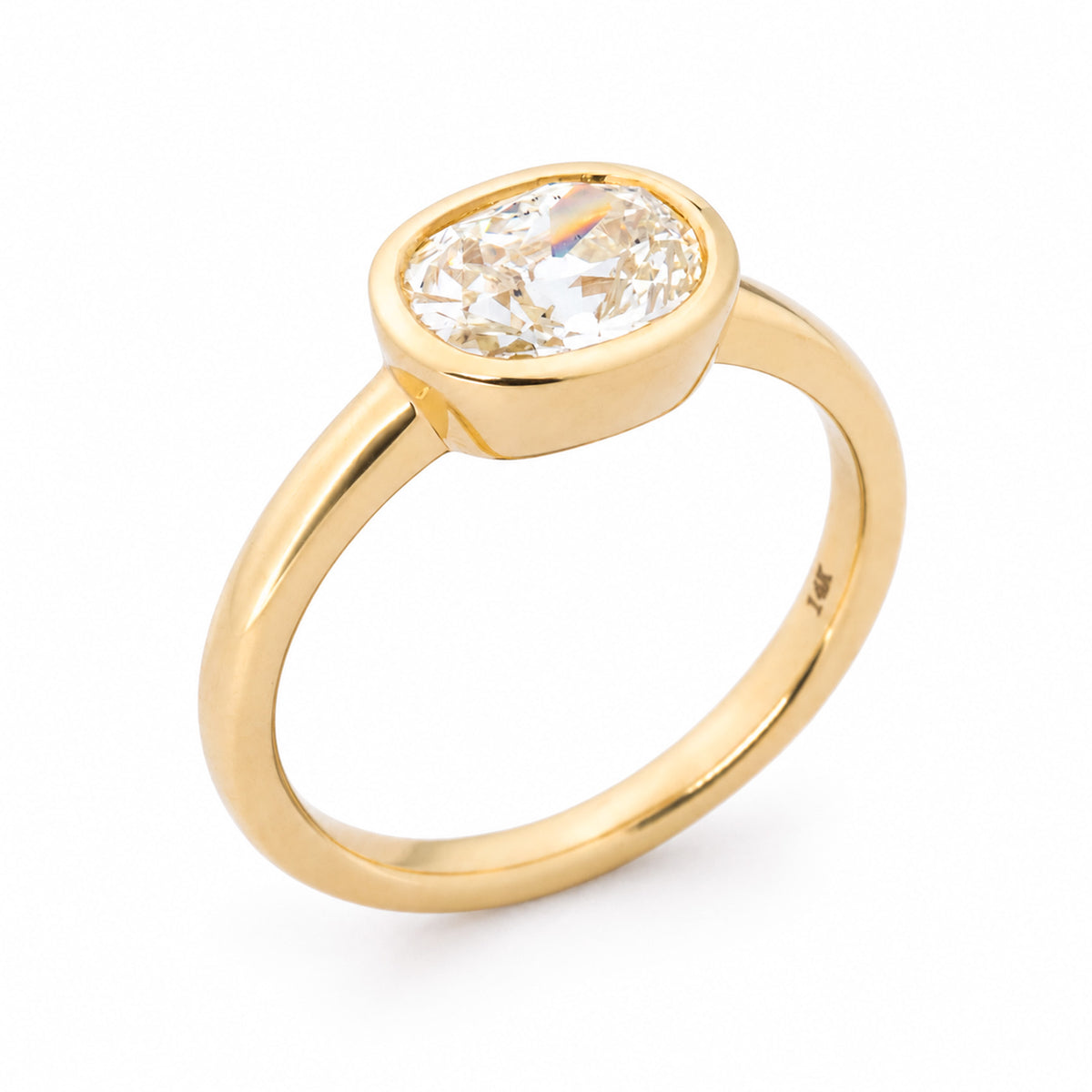 Angled product view of a vintage-inspired old-mine cut diamond ring, featuring an elongated cushion-shaped stone set in 14ct yellow gold.