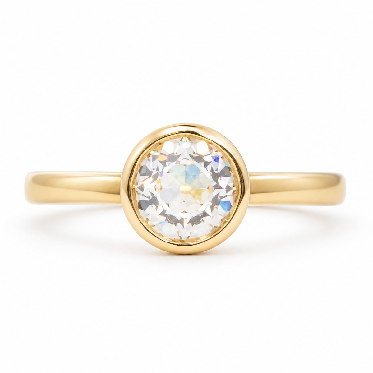 A front profile of an Antique-inspired, Old-cut diamond solitaire engagement ring set in 14k yellow gold.
