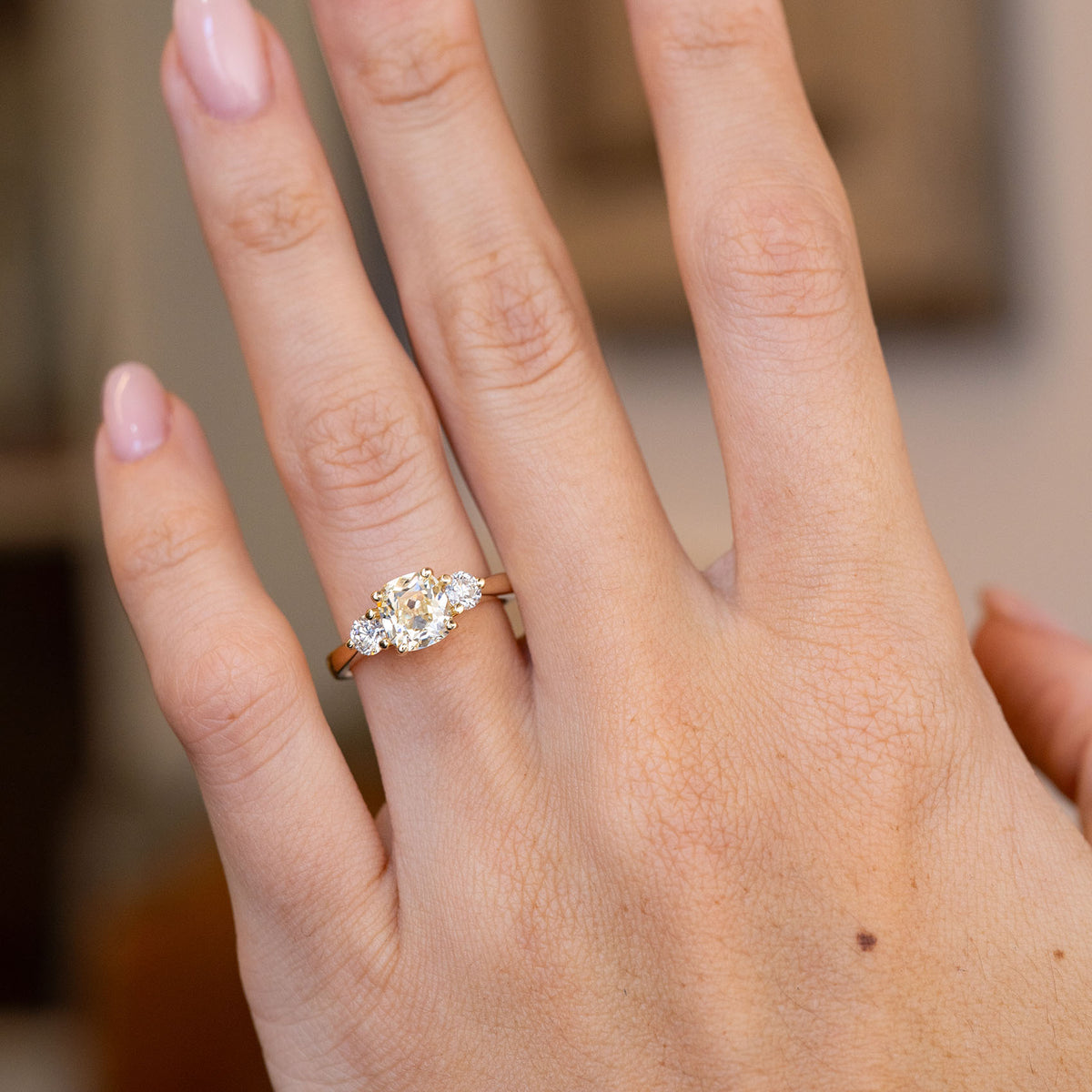 Natural hand view of the old-mine diamond engagement ring from a slight angle.