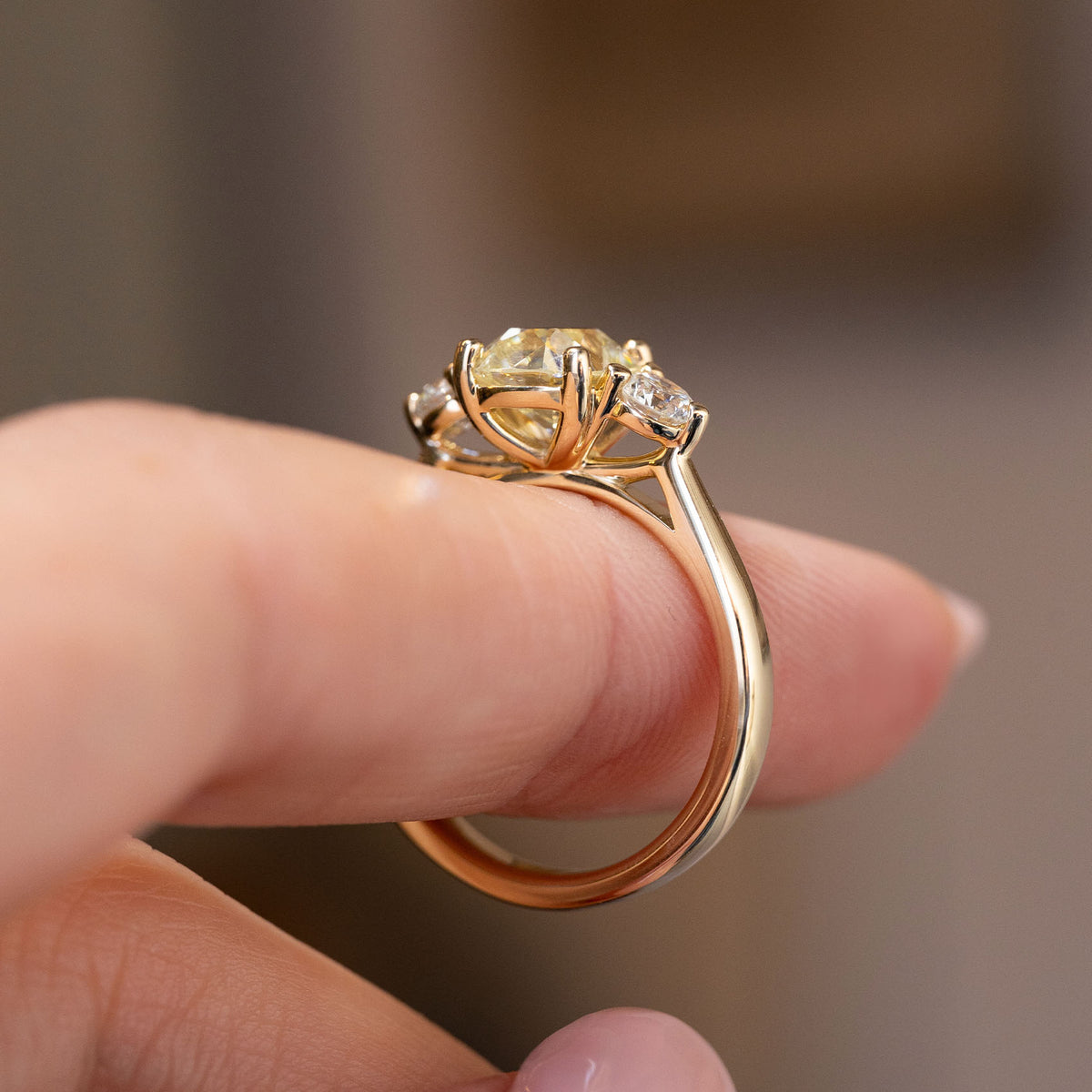 Side profile revealing the elevated setting and decorative open gold gallery.