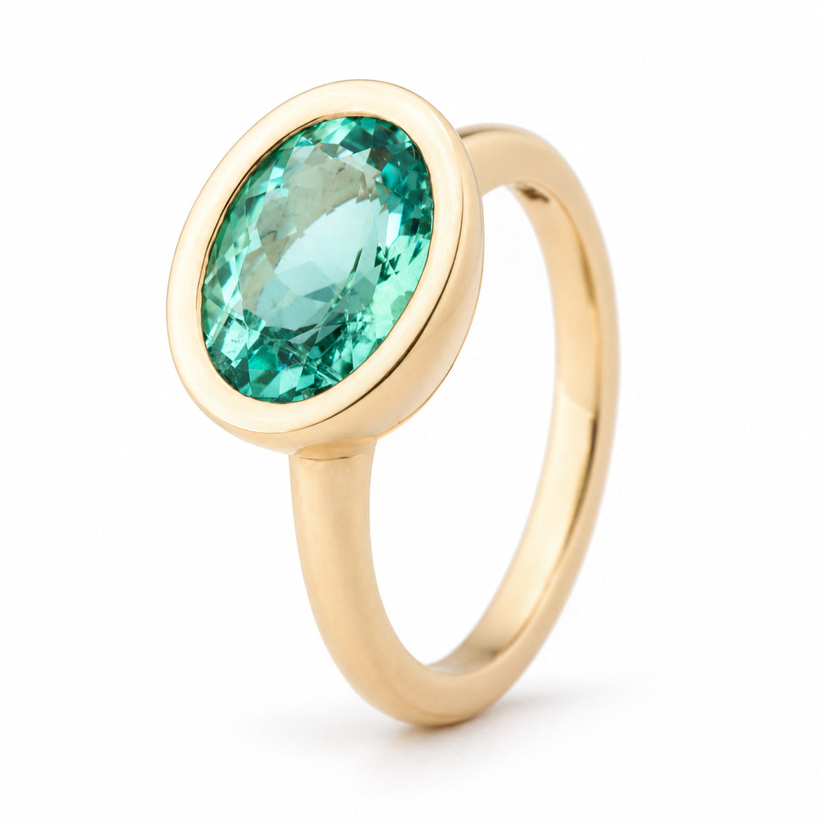 Angled view of the sea-green beryl ring, highlighting the oval gemstone and elegant yellow gold bezel setting.