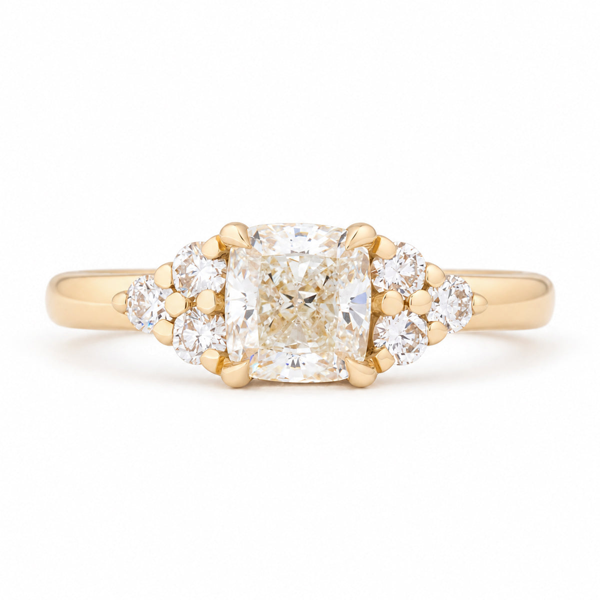 Vintage-inspired diamond cluster trefoil engagement ring in yellow gold, featuring a cushion-cut centre diamond and brilliant-cut diamond shoulders.